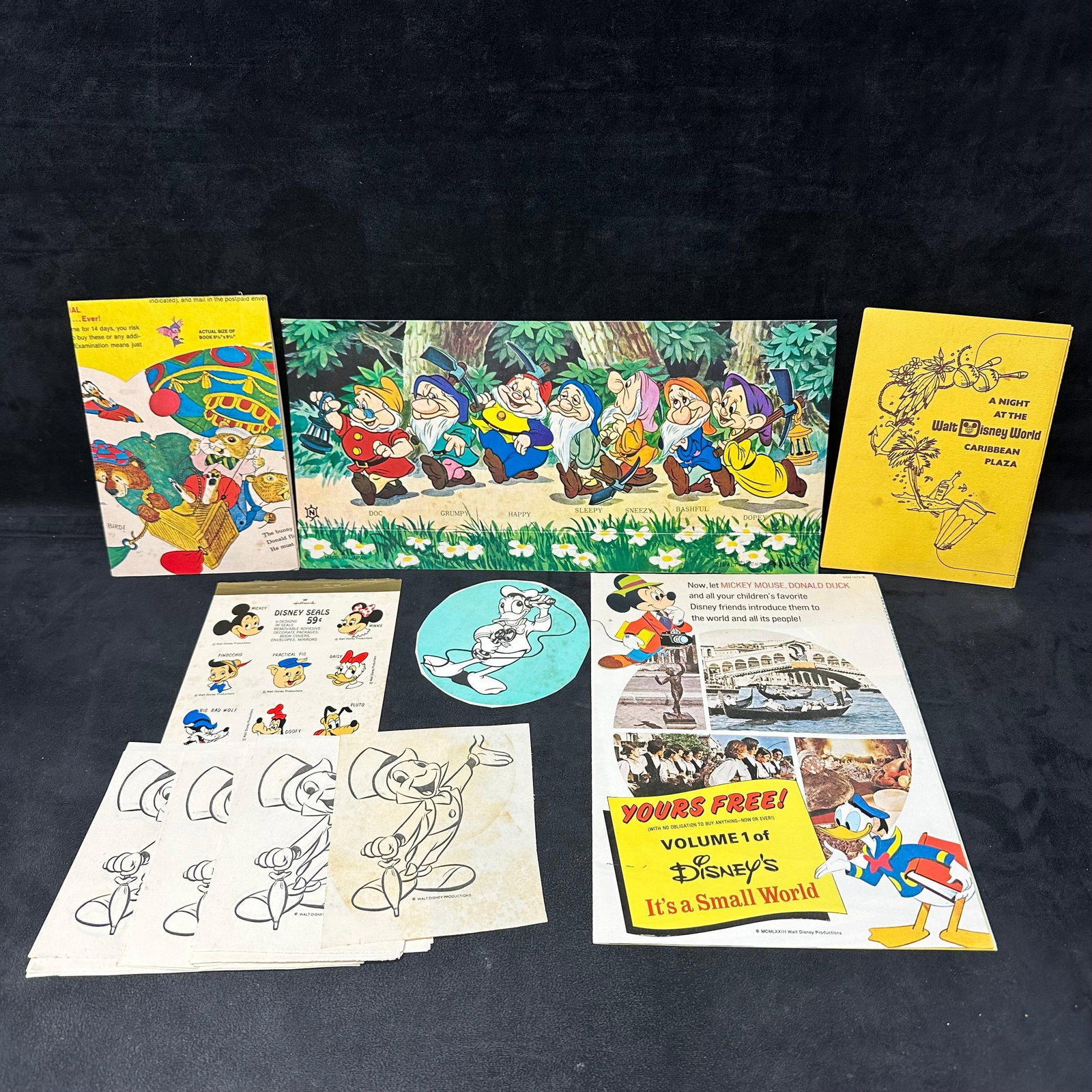 Disney Ephemera Paper Lot Snow White Mickey Mouse Donald Duck and WDW Caribbean Plaza: A mixed lot of vintage Disney paper ephemera, including a Snow White and the Seven Dwarfs fold-out print, Walt Disney World Caribbean Plaza event program, Disney character seals sheet, Mickey/Donald p
