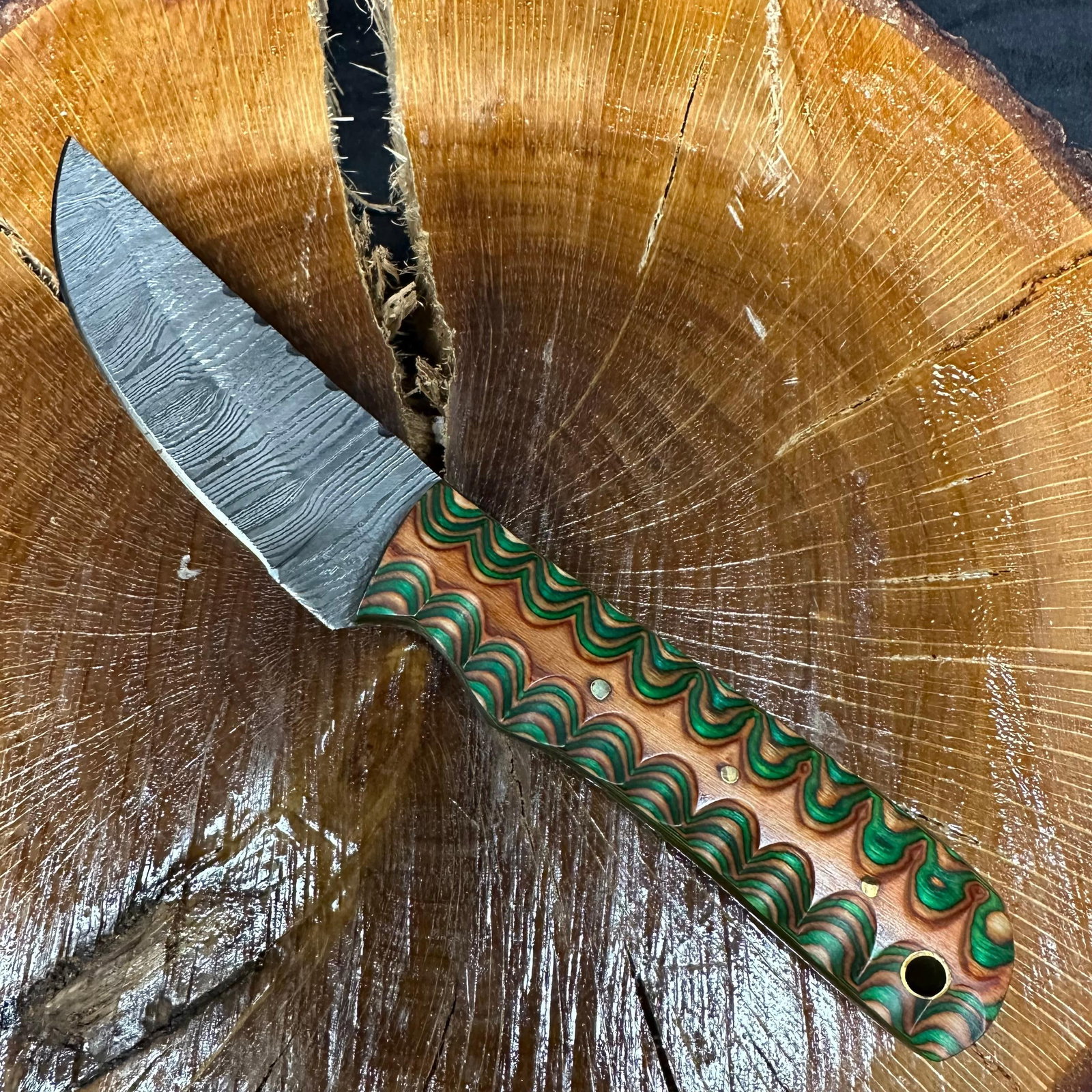 MHS Cutlery Steel Blade Knife Green Orange Colored Handle P36: Fixed blade knife by MHS Cutlery featuring a patterned steel blade. The handle is constructed with multi-tone stabilized material in orange and green hues, accented with mosaic pins and a lanyard