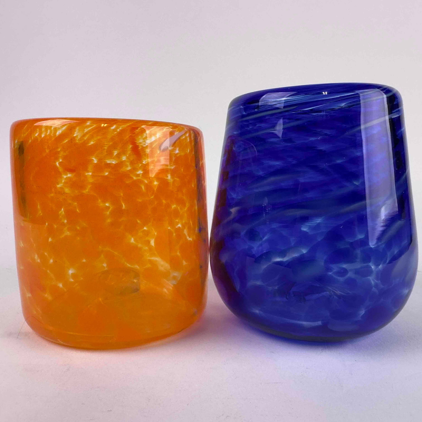 Hand Blown Art Glass Tumblers Orange and Cobalt Blue Spotted Murano Style Cup Set: Measurements: Blue - 4 1/4" tall, 2 3/4" diameter. Orange - 3 1/2" tall, 3 1/4" diameter. Weight: 1.8 lbs. This eye-catching pair of hand-blown art glass tumblers showcases
