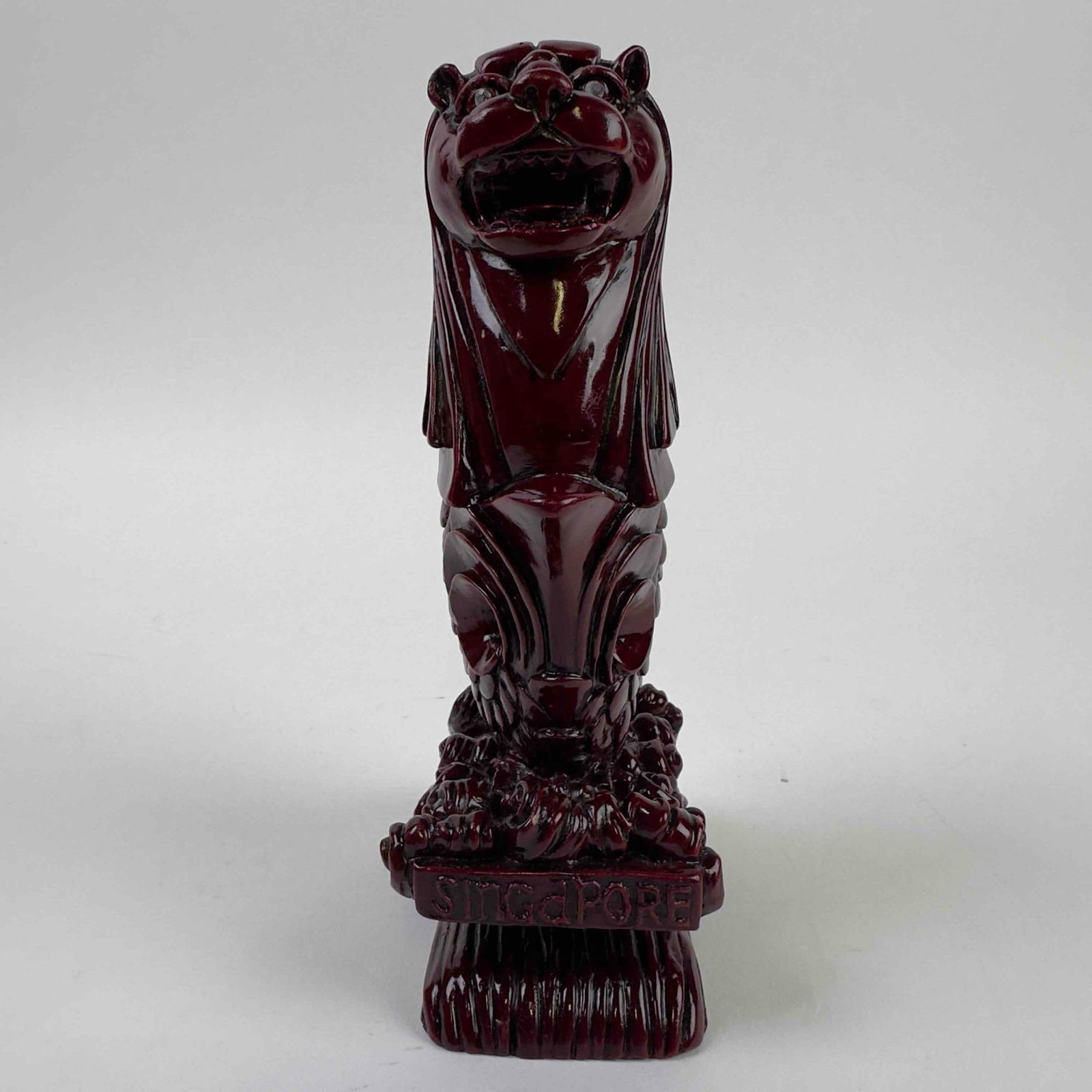 Red Wood Carved Singapore Merlion Sea Lion Statue Sculpture Figurine Paperweight: Red Wood Carved Singapore Merlion Sea Lion Statue Sculpture Figurine Paperweight. This piece has Singapore carved on the front with two crystal accents on the lions eyes and etched in detail