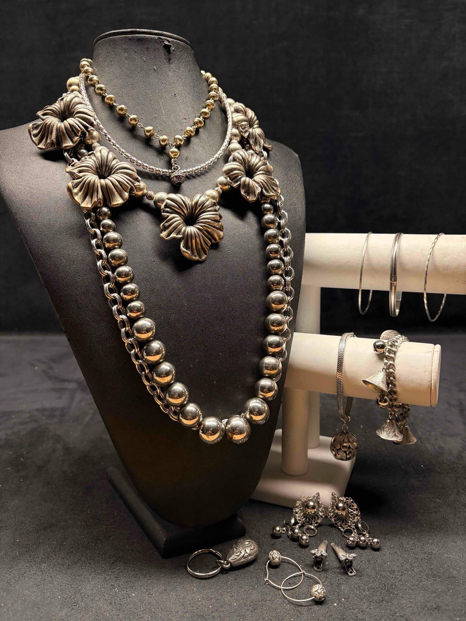 14pc Silver Toned Steel Magnolia Costume Jewelry Collection: This lot contains 14 pieces of pre-owned costume jewelry, paired together in a stylized set. Each piece is in good conditions, with wear and tear over the years visible on some of the jewelry. Please 