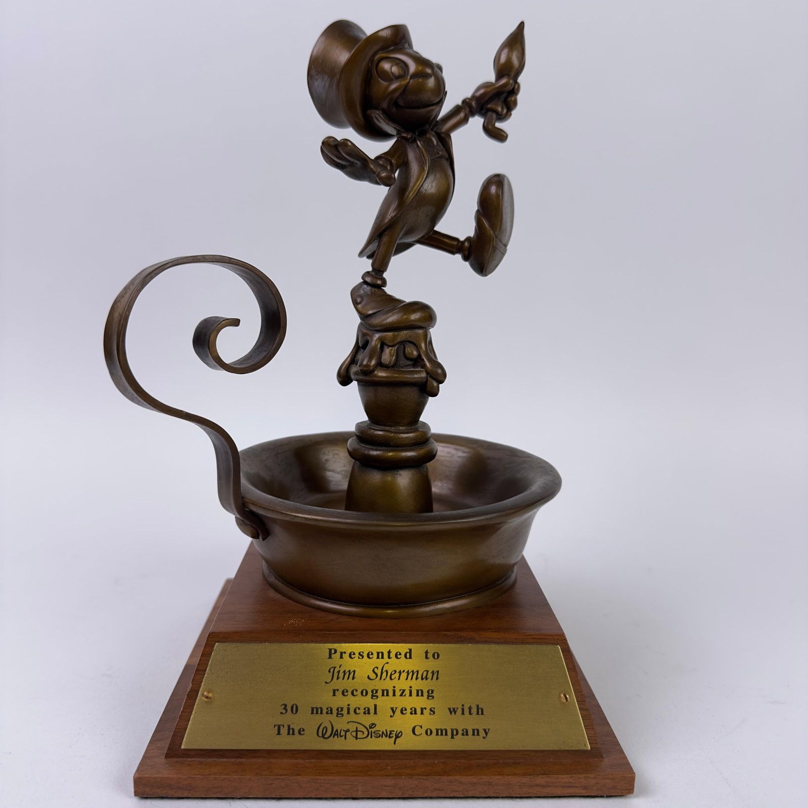 Jiminy Cricket Disney Cast Member 30 Years Service Award Bronze Statue Figure: Disney Cast Member 30 Years Service Award Bronze Statue Jiminy Cricket Figure. This 30-Year Service Award from Disney, featuring a bronze Jiminy Cricket standing on a candle, is an artifact of extraor