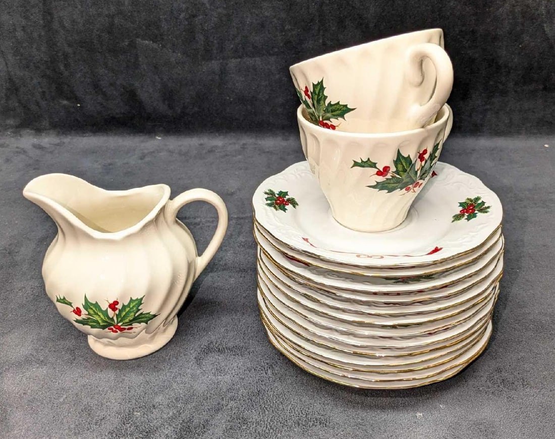 Vintage Christmas Holly Porcelain Saucers & Cups & Creamer: Vintage Christmas Holly Porcelain Saucers & Cups & Creamer. This lot includes: (13) Menuet Poland - Royal Vienna Collection. "Basket Of Cheer". Each is approx 6" x 6" x 3