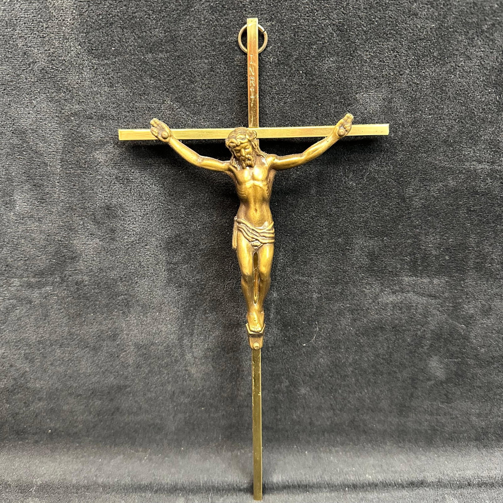 Brass Wall Crucifix Jesus on Cross with INRI Plaque: Vintage brass crucifix featuring a detailed figure of Jesus Christ on the cross, topped with an INRI plaque. Made of solid brass with a hanging loop for wall display. The piece shows nice patina consi