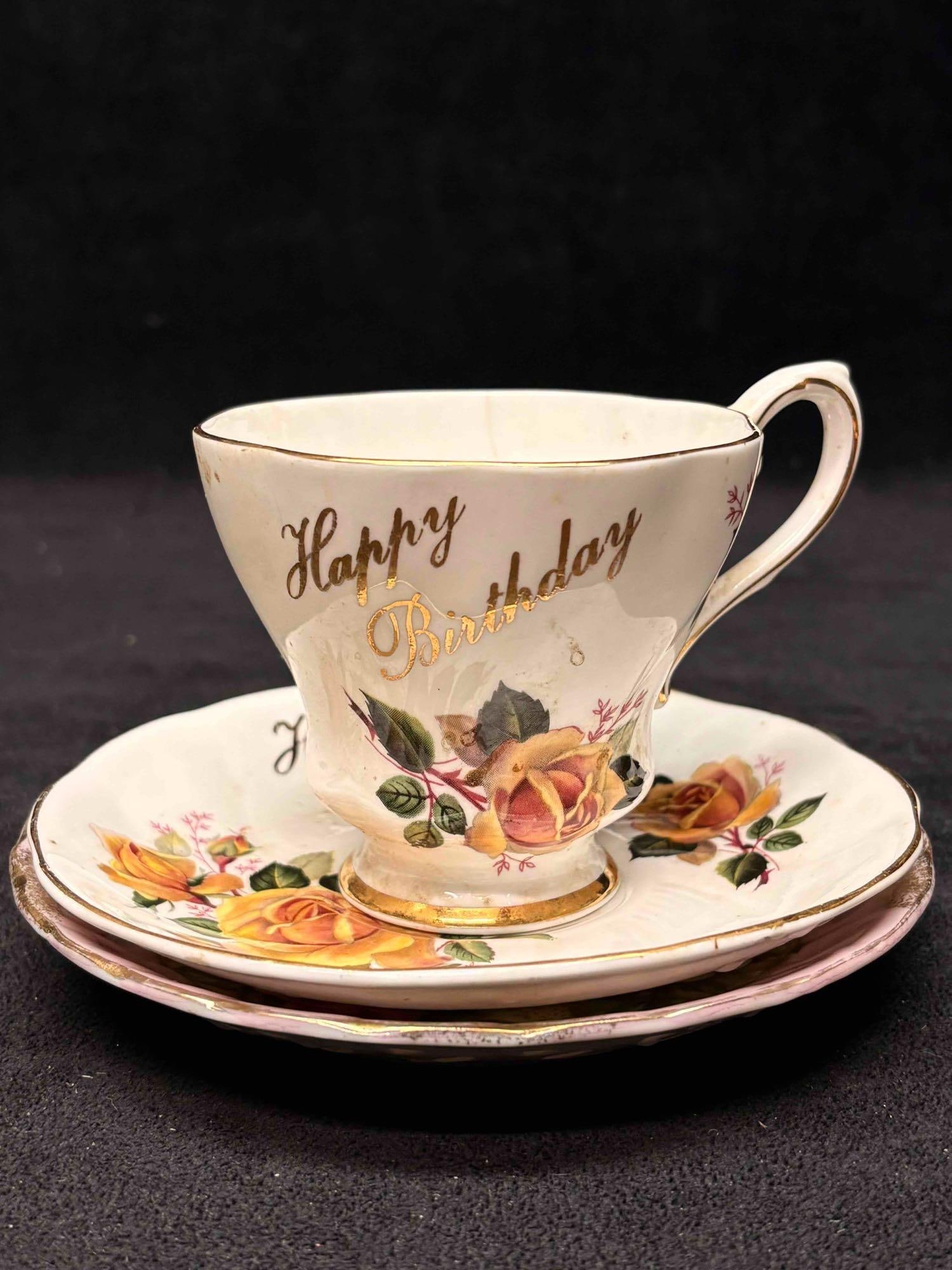 3pc Vintage Royal Grafton Happy Birthday Finebne Teacup and Saucer China: This lot comprises of the brand Royal Grafton's Happy Birthday teacup set and an antique Japanese floral saucer. While the Japanese saucer was not originally produced to be paired with the Royal G