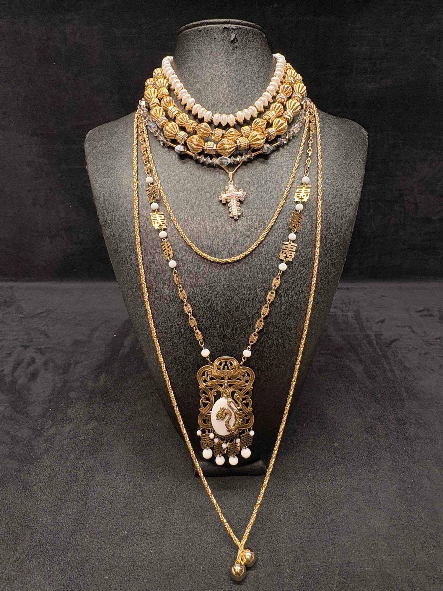 6pc Gold and White Chinese New Year Themed Necklace Lot: This lot consists of 6 pre-owned costume jewelry necklaces with typical wear from use. Please review images for context of the lots visual conditions. APPROX WEIGHT: 9.5 OZ