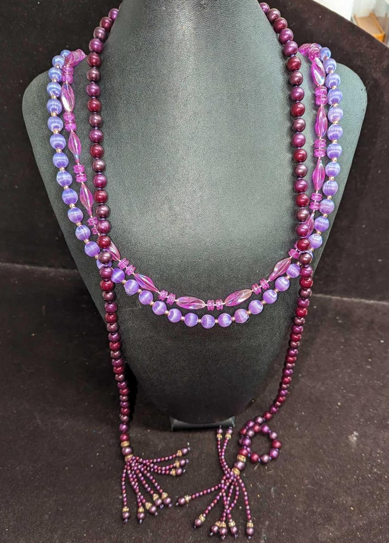 3 Vintage Purple Beaded Costume Necklaces: This lot includes: (1) Vintage Purple And Gold Tone Beaded Necklace. This is approx 30". (1) Purple Acrylic Bead Necklace. This is approx 36". (1) Purple Open-Ended Necklace. T