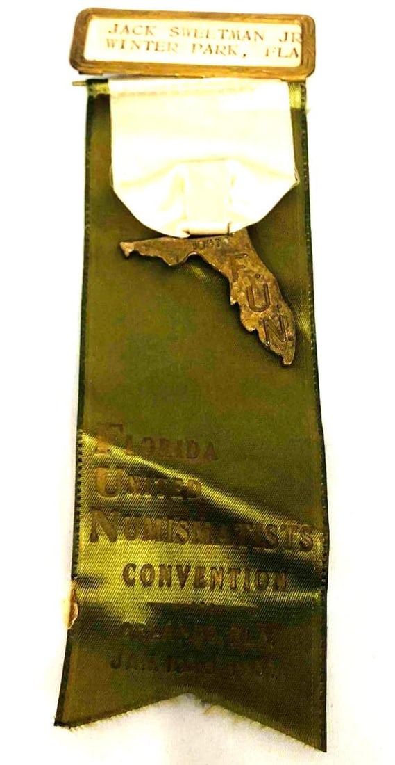 Florida United Numismatists Convention Medal 1957: This lot contains a Florida United Numismatists Convention Medal 1957. The medal features an olive tone ribbon with the a Florida pin engraved F.U.N. 1957. The convention was held in Orlando from Janu