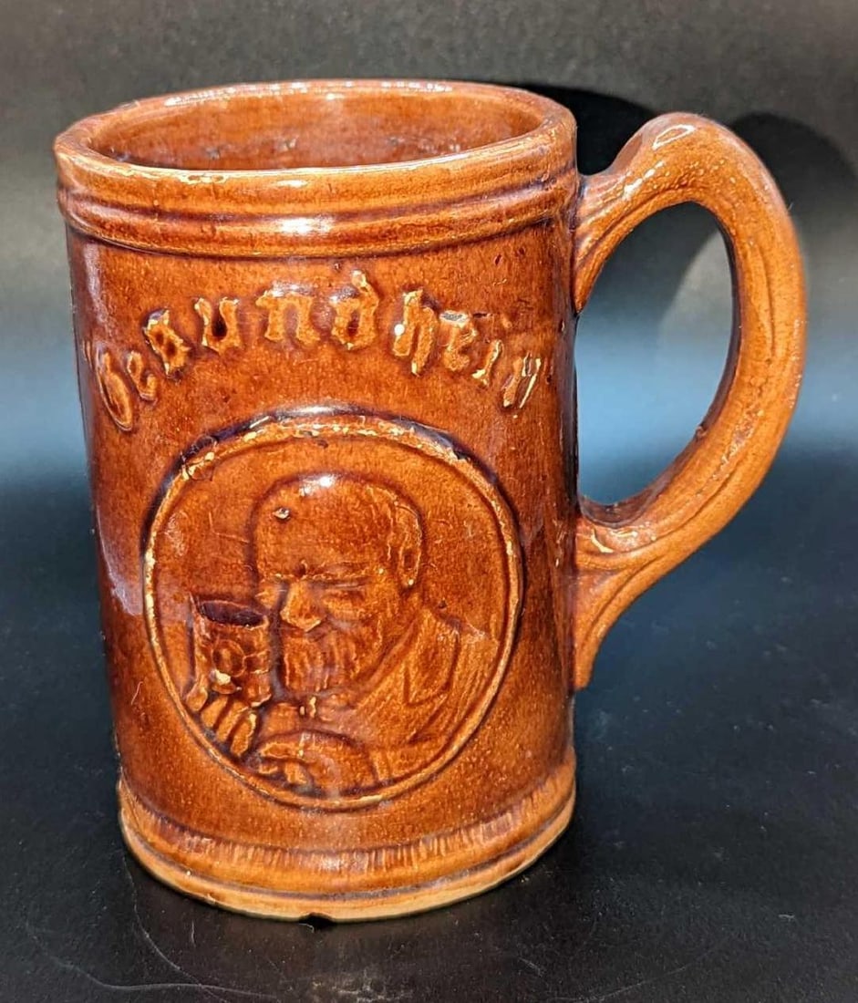 Vintage Gesundheit Ceramic Mug: Vintage Gesundheit Ceramic Mug. This is approximately 5" x 4" x 5" and it weighs 1.18lb The mug has some chips and color loss. From Neustadtl Brewing.