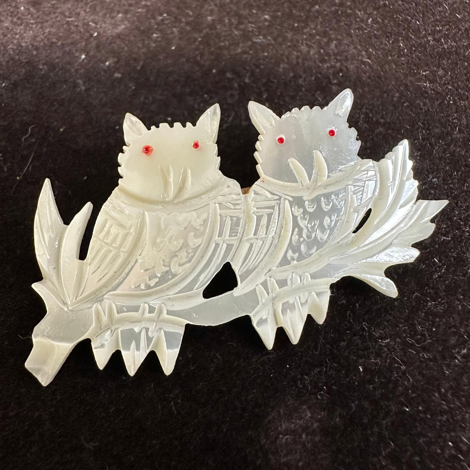 Pair of Owls Vintage Mother Of Pearl Hand Carved Brooch: Carved mother-of-pearl brooch featuring two owls on a tree branch. This item is in pre-owned, previously displayed condition with light wear and surface markings. Please reference all photos for full 