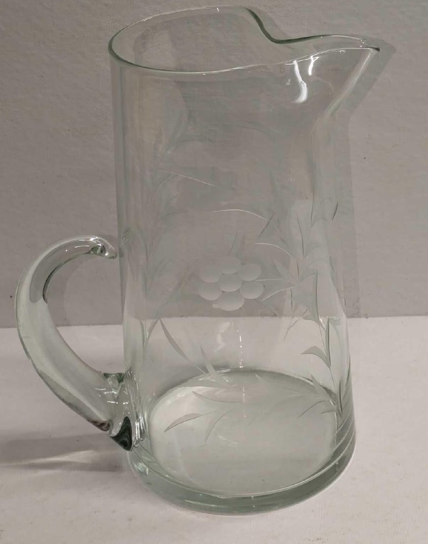 Vintage Glass Etched Floral Pitcher: Vintage Glass Etched Floral Pitcher. The maker and date of creation is unknown. This is approx 7" x 5" x 9 7/8" and it weighs 2.423lbs. There are some markings on the pitcher. Please see the ima