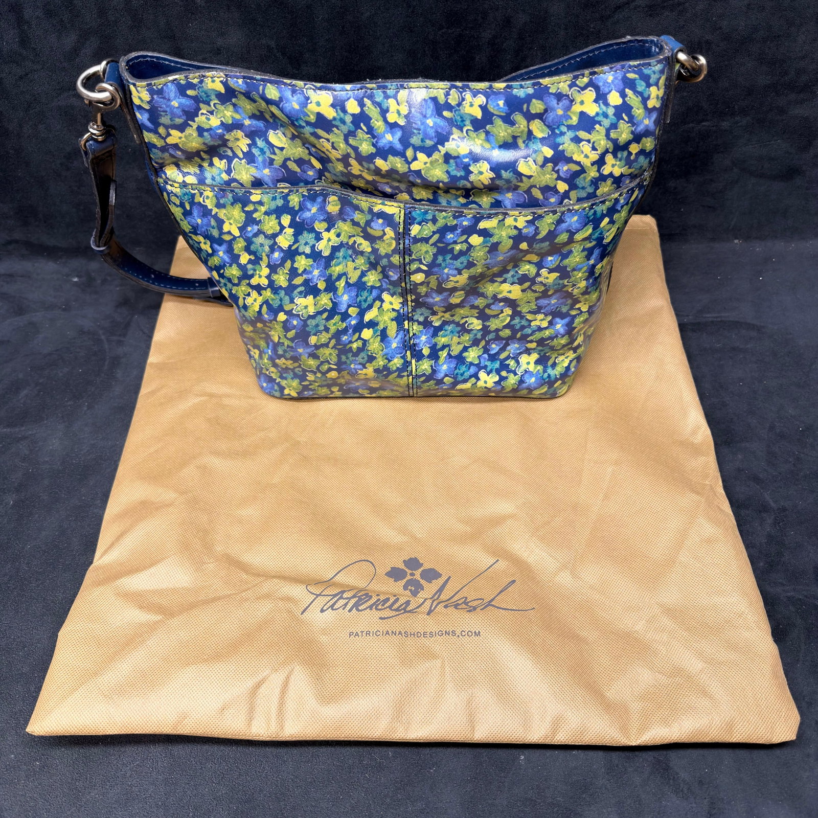 Patricia Nash Blue Floral Leather Crossbody Shoulder Bag: Patricia Nash genuine leather crossbody/shoulder bag featuring a blue floral print exterior with matching blue leather trim and silver-tone hardware. The bag includes an adjustable shoulder strap, mag