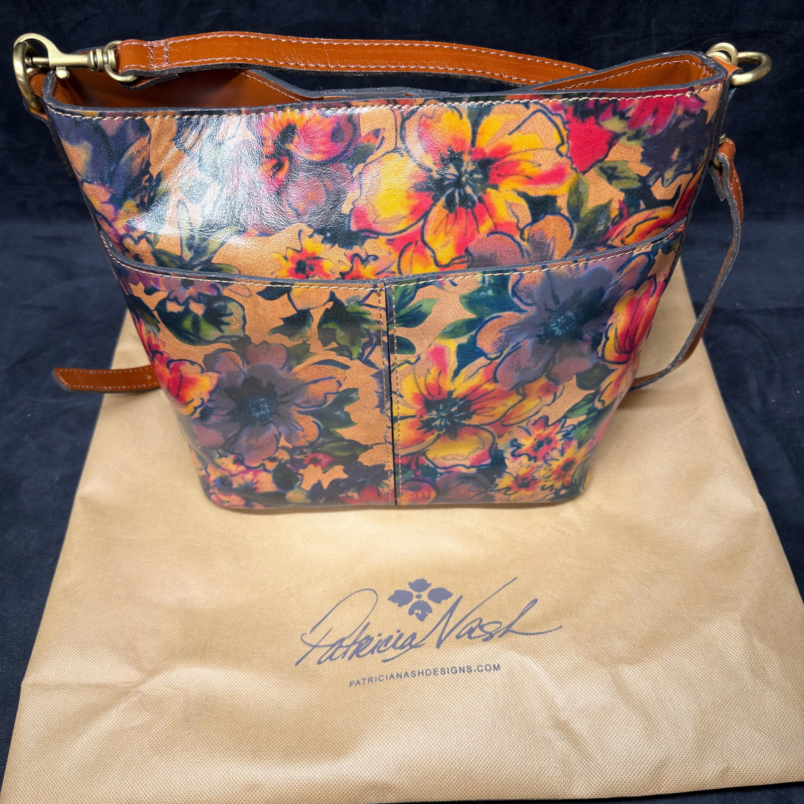 Patricia Nash Floral Leather Crossbody Shoulder Bag with Dust Bag: Patricia Nash genuine leather crossbody/shoulder bag featuring a vibrant floral print exterior with tan leather trim and brass-tone hardware. The bag includes an adjustable shoulder strap, magnetic sn