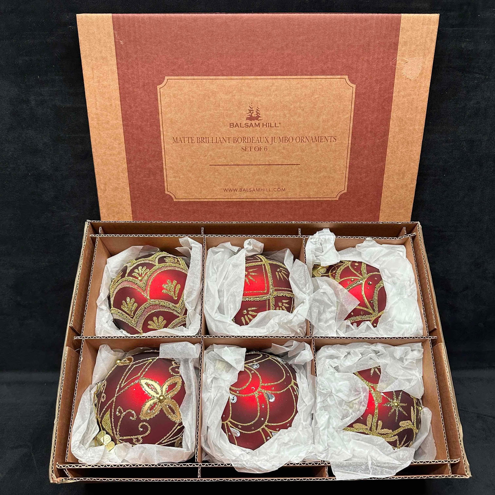 Balsam Hill Brilliant Bordeaux Matte Ornament Set of 6 Burgundy Red Glass: Burgundy and gold glass ornaments. Intricate beadwork and glitter accents. Set of 6 featuring extra large burgundy spheres each with a unique gold pattern and matte finish. Crafted from mouth-blo