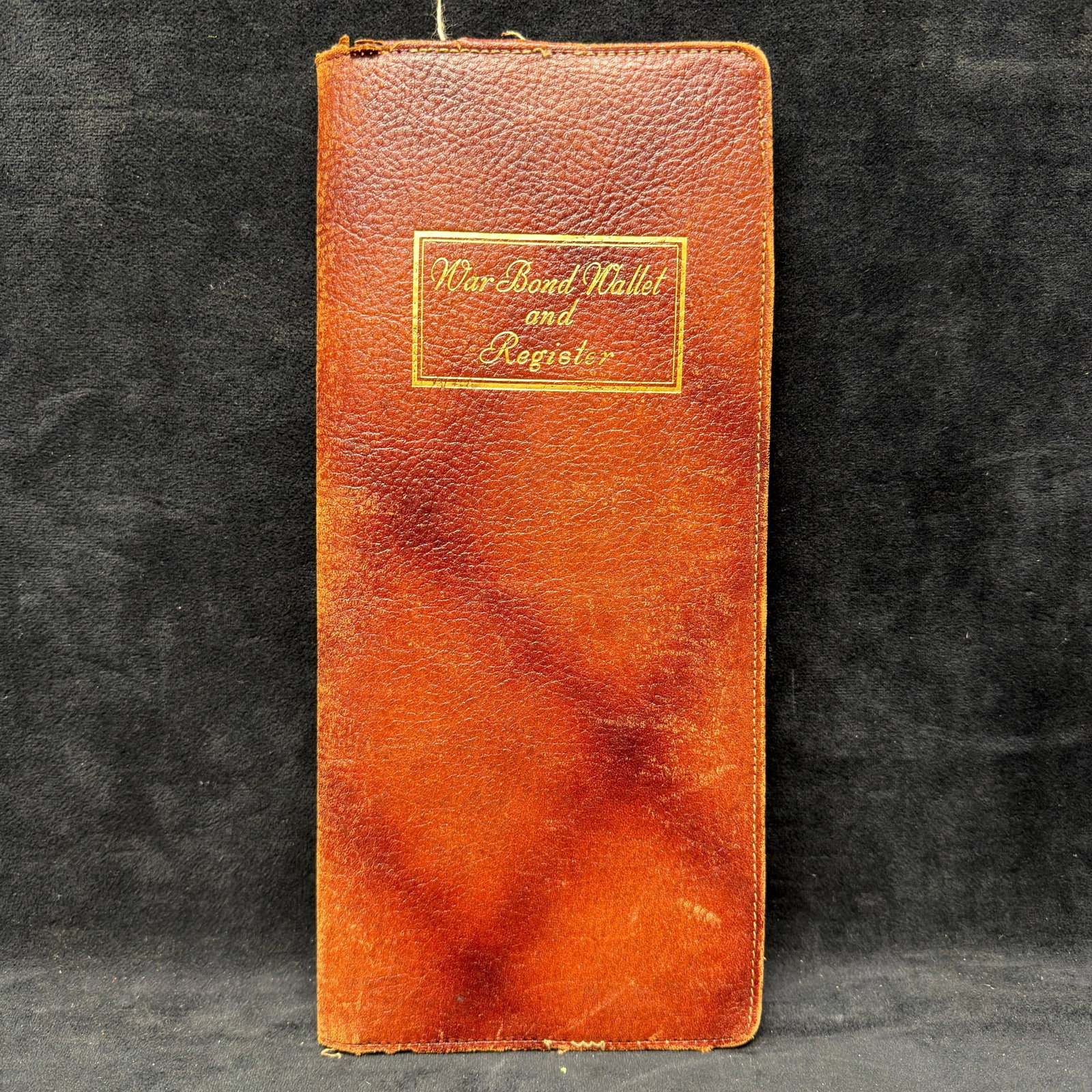 Brown Genuine Leather War Bond Wallet and Register: Vintage WWII-era brown leather war bond wallet and register. Heavy wear, minor rips and tears on the piece. Noticeable damage. This item is in pre-owned, previously used/displayed condition with light