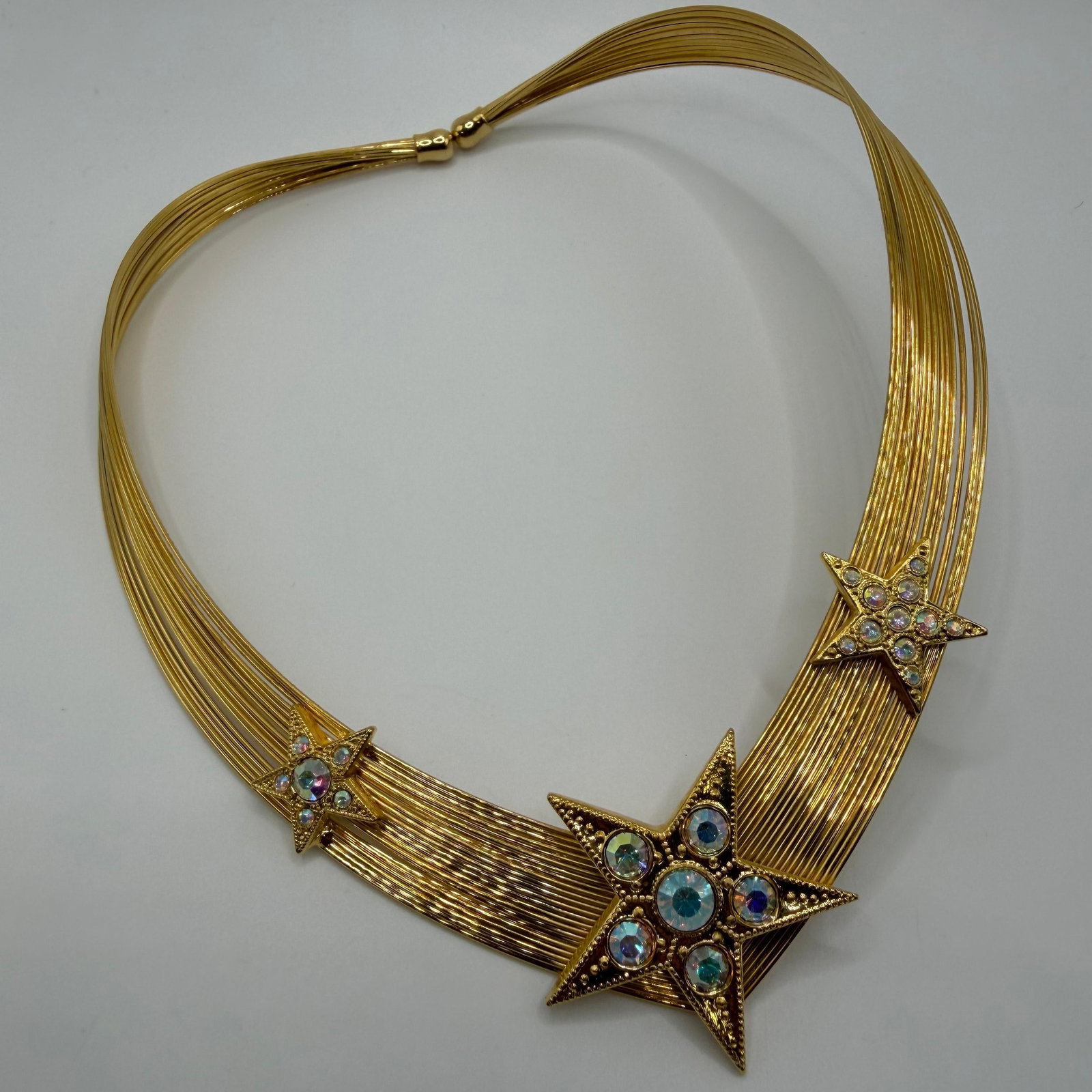 Celestial Rising Star Kirks Folly Choker Collar Necklace Three Stars: This is a vintage Kirks Folly choker necklace featuring gold-tone memory wire and rhinestone crystal embellishments. Includes original Kirks Folly pink box. This item is in good pre-owned, previously 