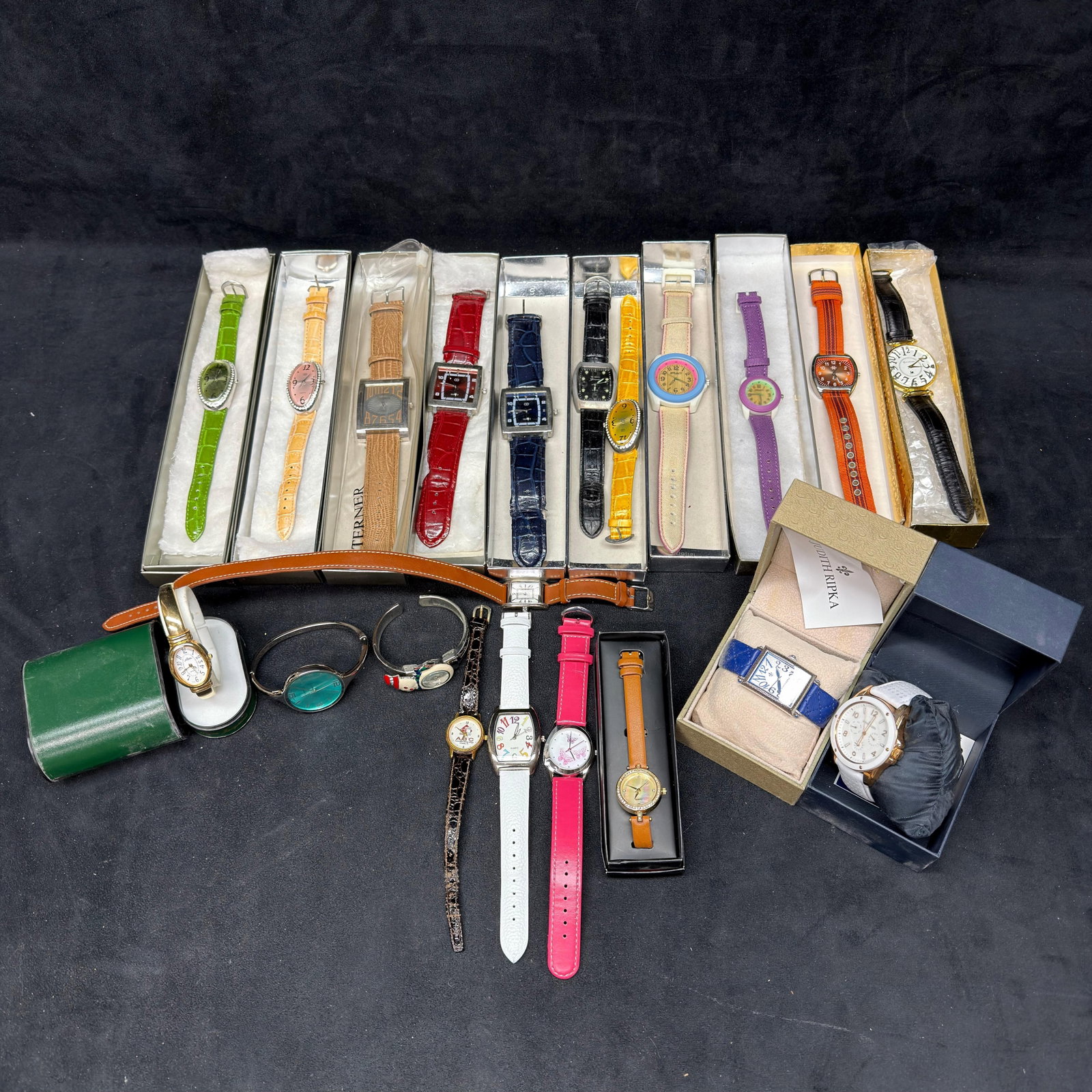 Large Assorted Fashion Wristwatch Collection Judith Ripka Gloria Vanderbilt Swarovski: Large assortment of approximately 20+ fashion wristwatches in a variety of colors, styles, and brands, including Judith Ripka, Genevex, Anne Klein, and other fashion makers. Features faux leather,