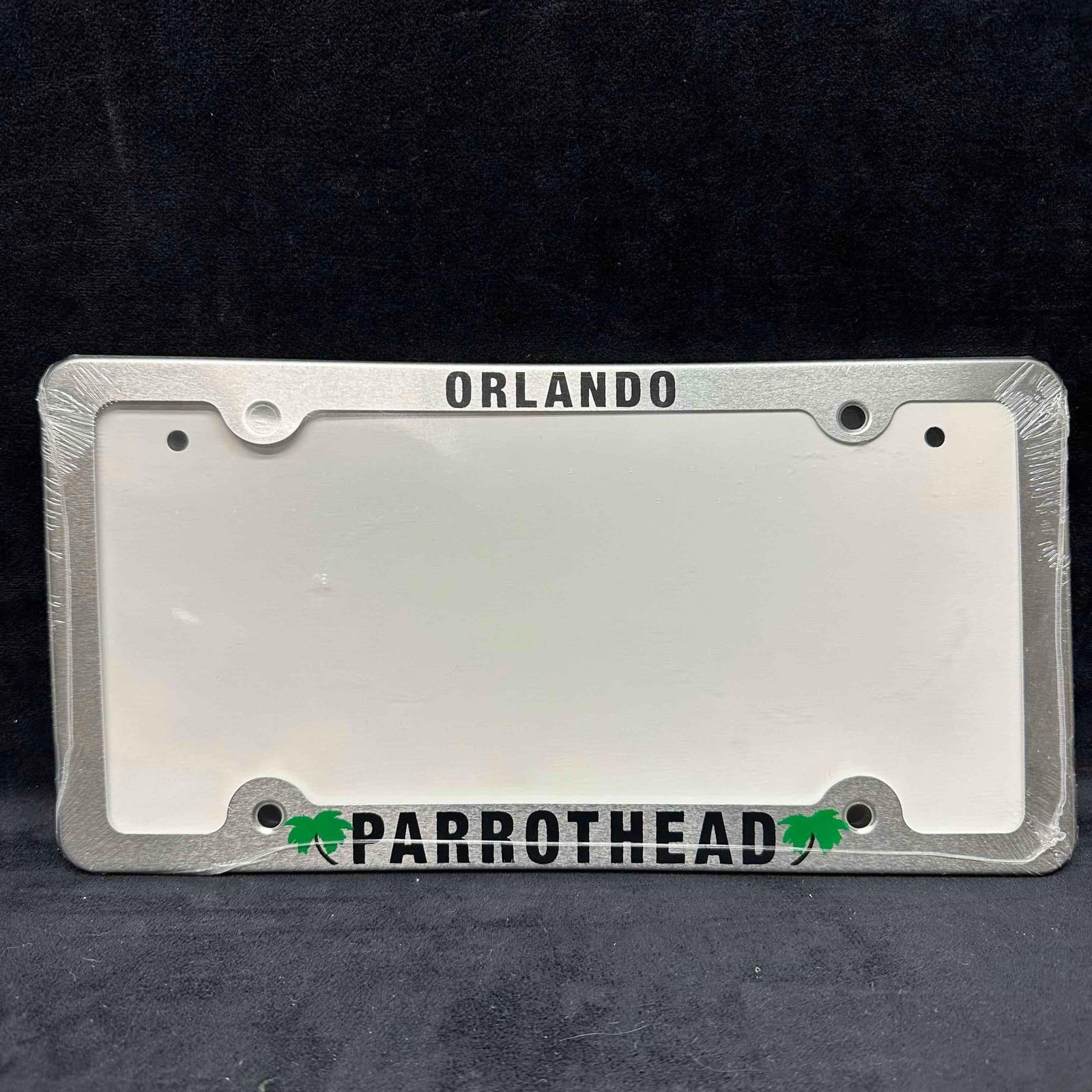 Orlando Parrot Head Car Tag License Plate Plastic Frame Holder Margaritaville: Margaritaville Jimmy Buffet thin metal plastic design silver tone license plate frame tag holder, featuring Orlando and Parrothead with two palm trees. Parrot Head is a commonly used nickname for fans