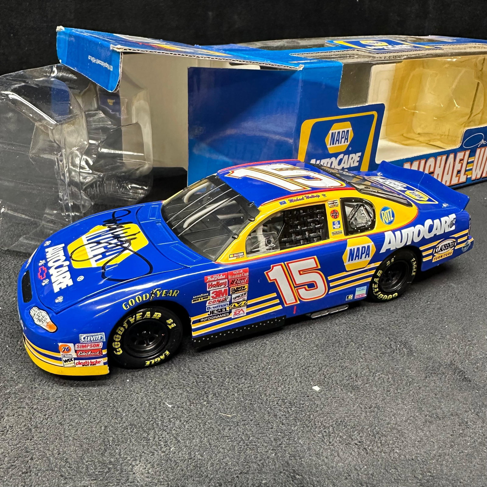 Michael Waltrip Signed NAPA Racing Chevrolet Monte Carlo 1:24 Diecast Stock Car #15: Limited edition 1:24 scale NASCAR diecast featuring Michael Waltrip’s #15 NAPA Auto Parts Chevrolet Monte Carlo. The car is hand-signed on the hood by Michael Waltrip in black marker. Produced b