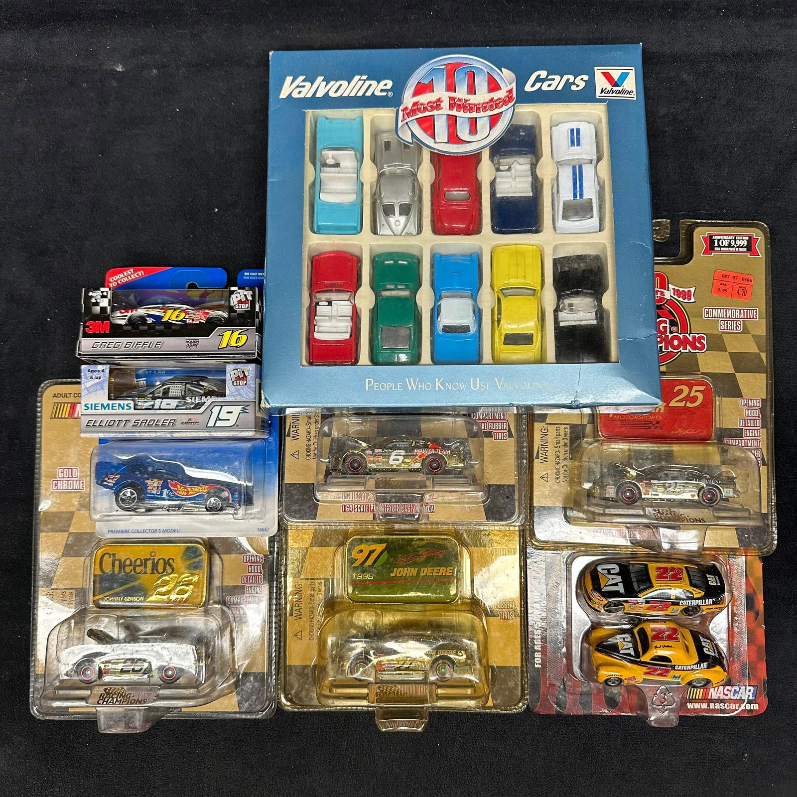 Mixed Lot NASCAR Diecast Cars and Valvoline 10 Most Wanted Collector Car Set Racing Champions: Mixed group of diecast collectible cars, including NASCAR Racing Champions models and a Valvoline promotional collector set. The lot includes a boxed Valvoline “10 Most Wanted Cars” diecas