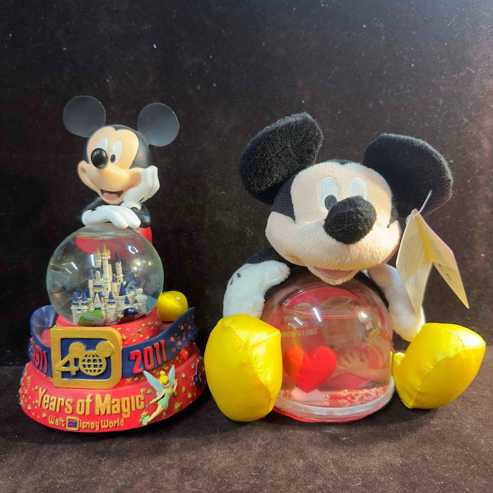Mickey Mouse Plush Photo Snowglobe Disney Parks 40 Years of Magic Musical Snow Globe Set: Mickey Mouse Plush Photo Snowglobe Disney Parks 40 Years of Magic Musical Snow Globe Set. Included in this lot are two Mickey Mouse collectibles, one being a authentic Disney Parks Musical snow globe 