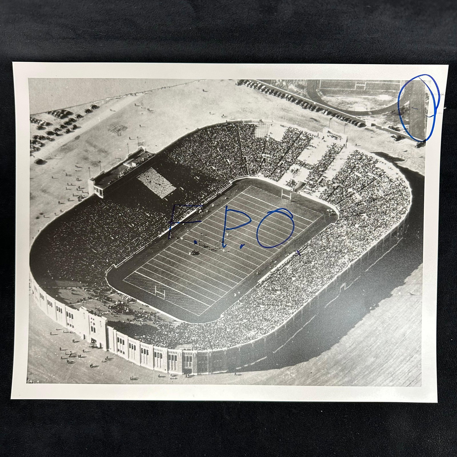 Vintage Analog Photo Print Aerial View of Stadium with Crowd Marked "F.P.O" and Notations: Offered here is a vintage analog black and white photo print featuring a packed stadium in aerial perspective. The image captures the full venue, filled with spectators, and includes the surrounding g