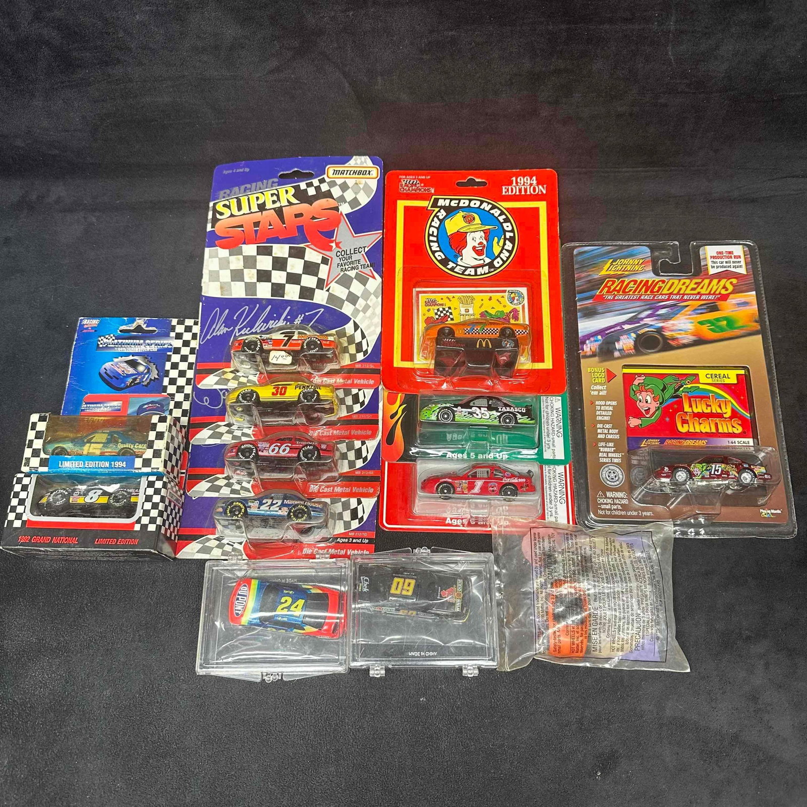 NASCAR Diecast Car Lot Matchbox Racing Superstars Johnny Lightning Lucky Charms, McDonald’s: Large mixed lot of vintage NASCAR diecast cars and collectibles. Includes Matchbox Racing Superstars Alan Kulwicki #7, Pennzoil #30, #66, and #22 cars in original packaging, Johnny Lightning Racing Dr