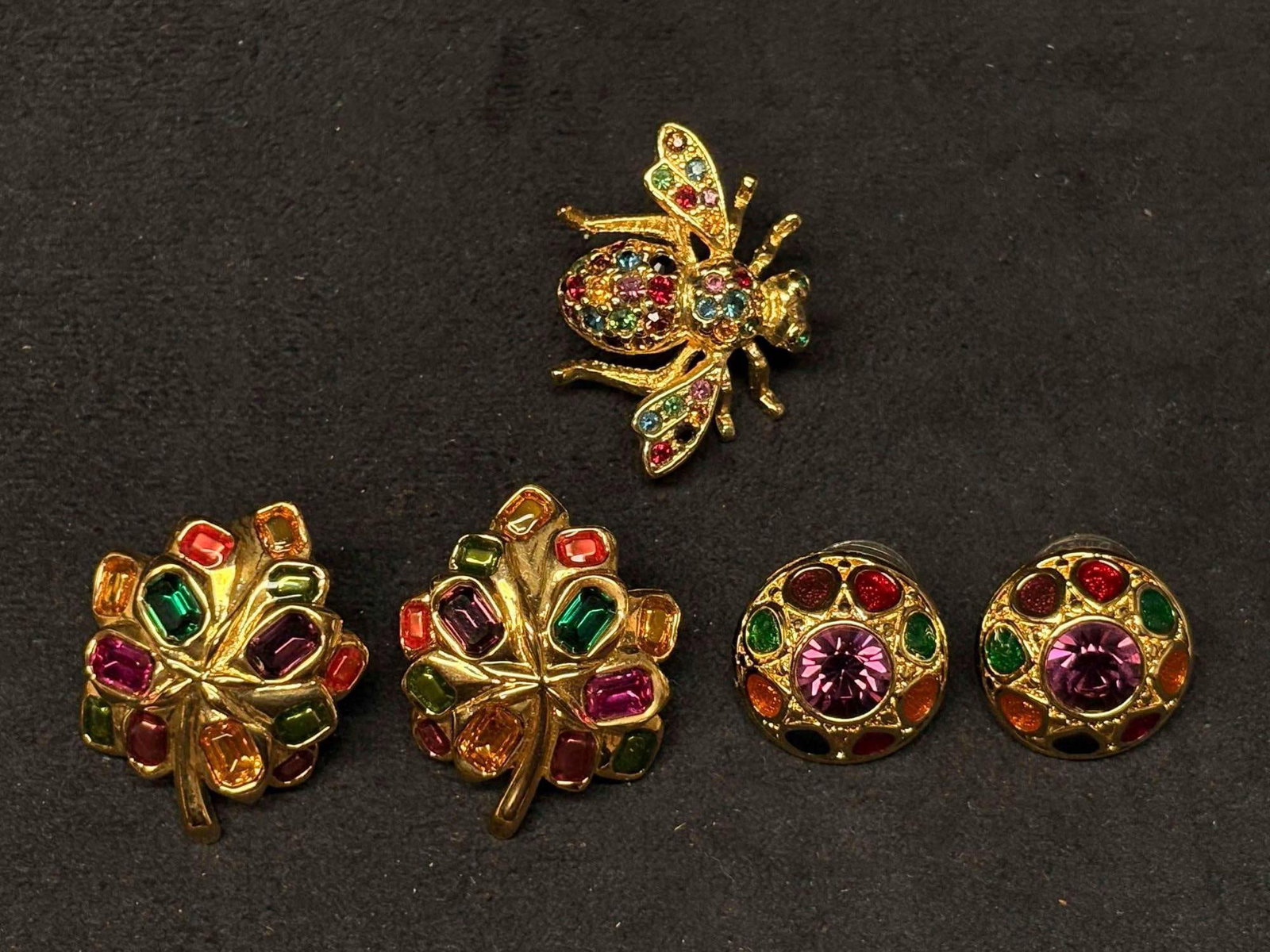Joan Rivers Multicolor Rhinestone Jewelry Group Earrings and Brooch: Joan Rivers costume jewelry group, including a pair of multicolor gemstone-style clip-on earrings, a pair of matching multicolor dome clip-on earrings, and a multicolor rhinestone bee brooch. Gold-ton