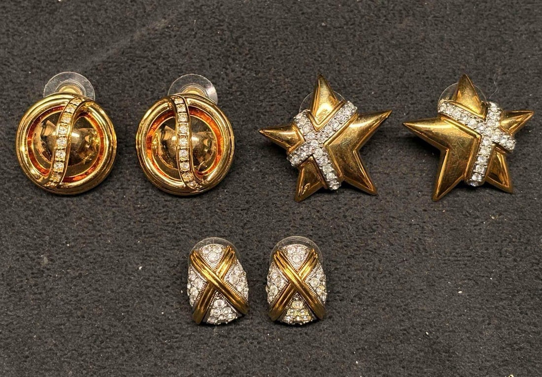 3pc Joan Rivers 1990s Classics Collection Earring Set featuring X Motifs: Group of three pairs of Joan Rivers gold-tone clip-on earrings featuring rhinestone accents and geometric designs. Includes a pair of orb-style earrings, star motif earrings, and pave-style crossover