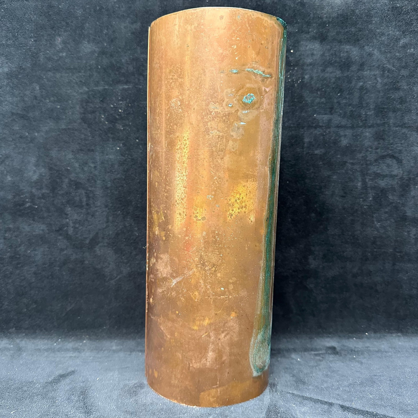 Copper Cylindrical Form Architectural Salvage Scrap Tube Hollow Cylinder: Solid copper cylindrical form with visible seam, natural patina, and oxidation throughout. Untreated surface showing age, wear, and verdigris consistent with prolonged exposure and use. Likely archite