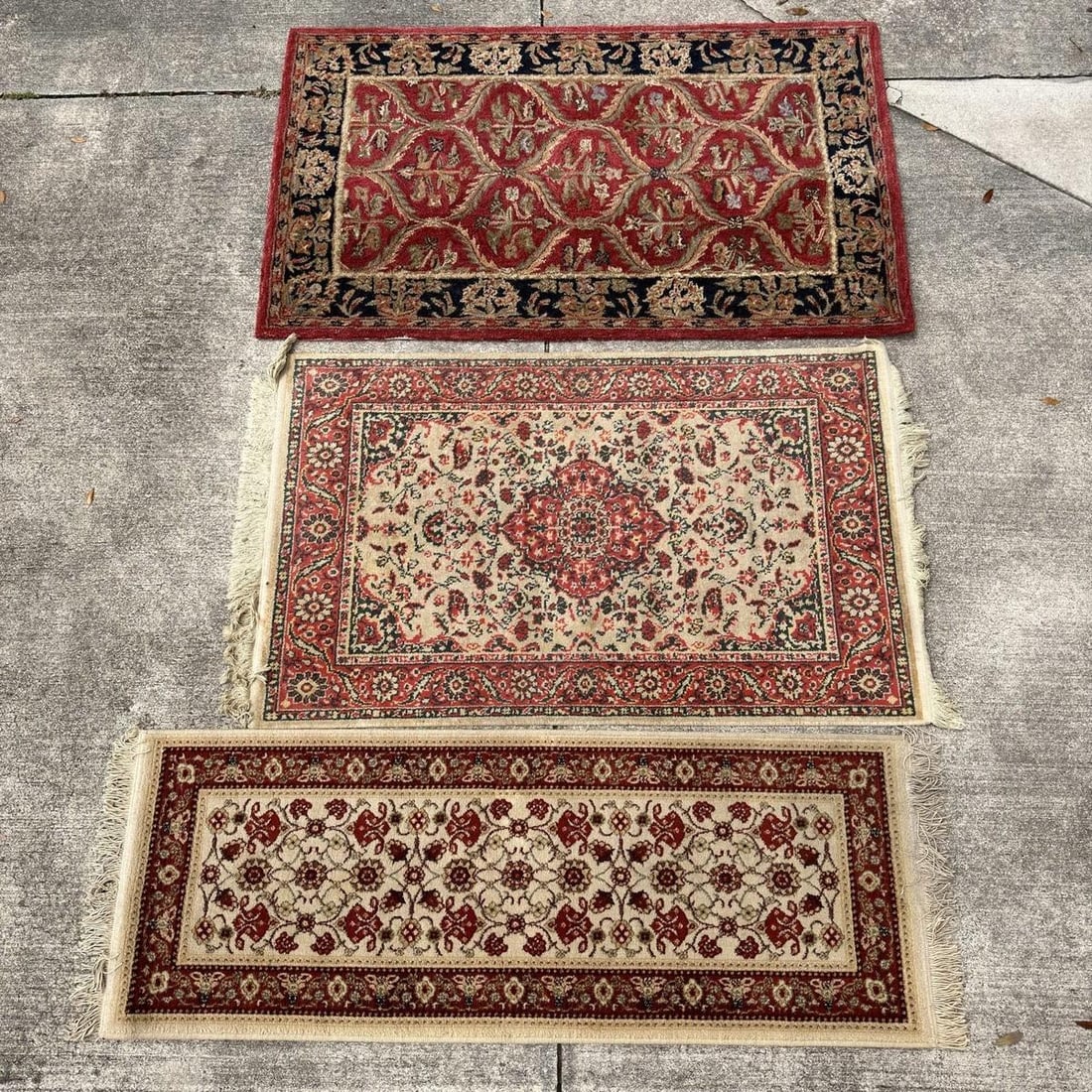 Three Decorative Wool Area Rugs Including Safavieh Anatolia: Group of three decorative wool area rugs, including a Safavieh Anatolia rug (label retained) along with two coordinating traditional-style accent rugs. Features floral and medallion designs in red, iv