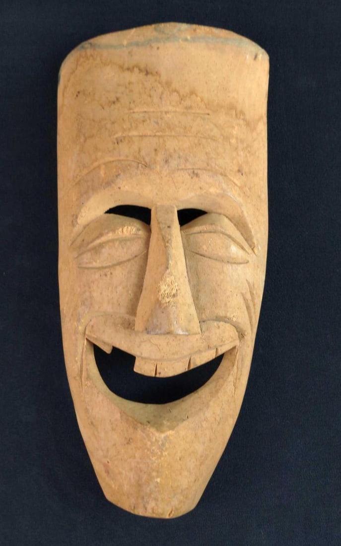 Replica Vintage African Style Tribal Mask Laughing: Here is a hand-carved wooden replica African style tribal mask. This one is missing a tooth and is laughing. The mask is approx 7" x 14" x 3". There is some wear and someone (or something) took a chun