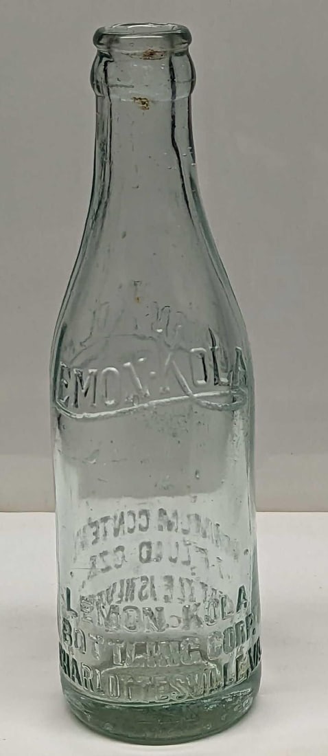 Antique Lemon Kola Glass 7oz Bottle: Antique Lemon Kola Glass 7oz Bottle. This is approx 2 1/2" x 7 5/8" and it weighs 0.80lb. The bottle has scratches, wear, and small chips. Please see the images as they are part of the description.