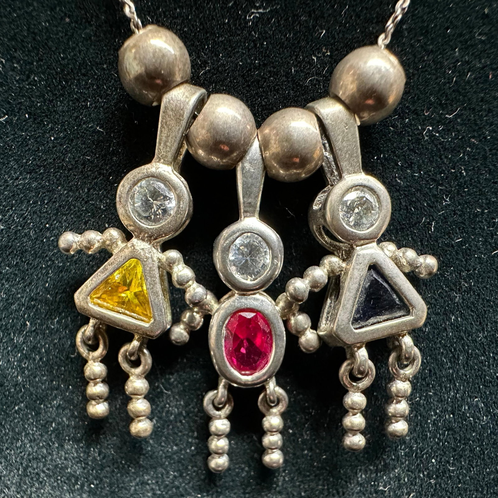 925 Italy Birthstone Three Child Figure Pendant Sterling Silver Necklace: This item is in good pre-owned, previously used/displayed condition with noticeable light wear and surface scratches. Please reference all photos for full details. This piece of jewelry has been teste