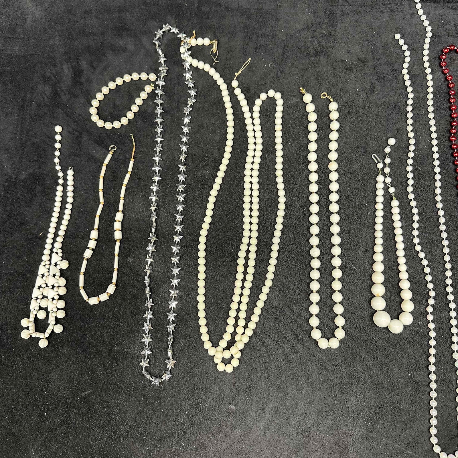 Costume Jewelry Beaded and Faux Pearl Necklace Collection Multi-Strand Assortment Set J11: Assorted vintage costume necklaces and one bracelet featuring faux pearl strands, white beaded necklaces, crystal-style star cut plastic beads, and one strand of metallic red plastic beads. Includes b
