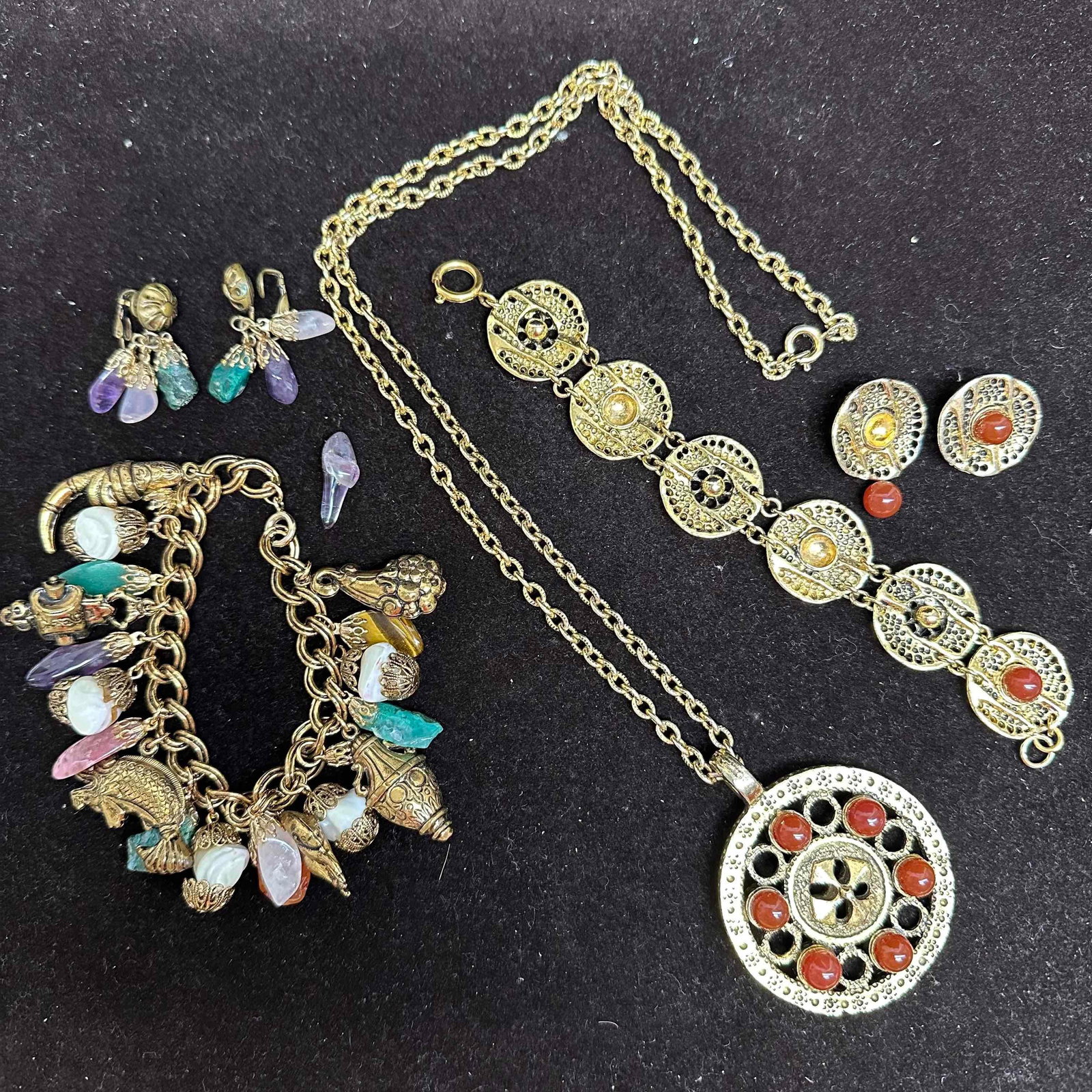 Two Vintage Costume Jewelry Sets Natural Stone Accents Broken Missing Stones: Two vintage gold-tone costume jewelry sets with natural stone accents. Includes a charm bracelet with figural charms and assorted stones (amethyst, quartz, agate, carnelian, faux pearls) with matching
