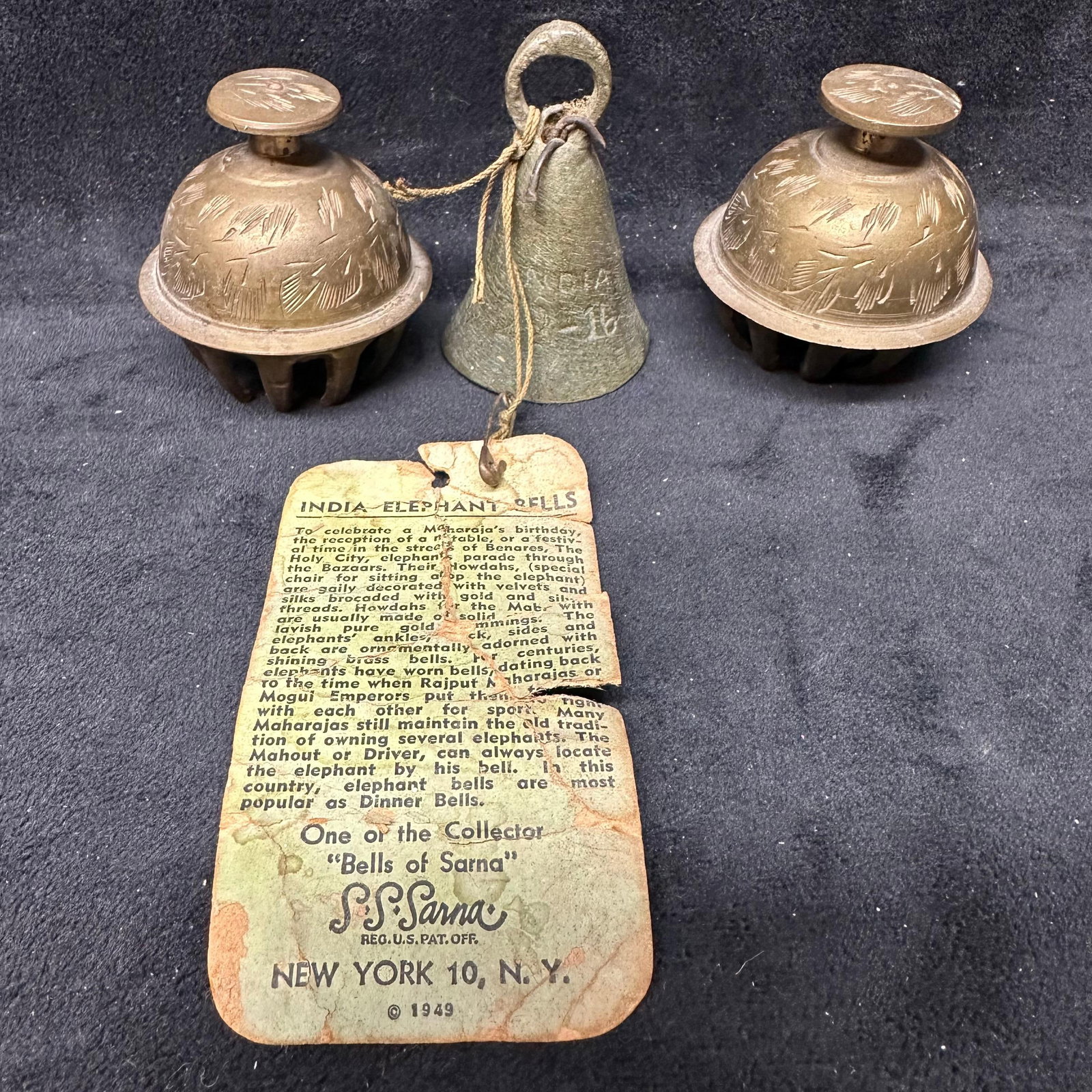 Vintage India Elephant Bell S. S. Sarna 1949 Three Bells: Group of three vintage Indian elephant bells, including two dome-form bells and one traditional conical bell. One bell retains the original S. S. Sarna India Elephant Bells paper tag, dated 1949, New 