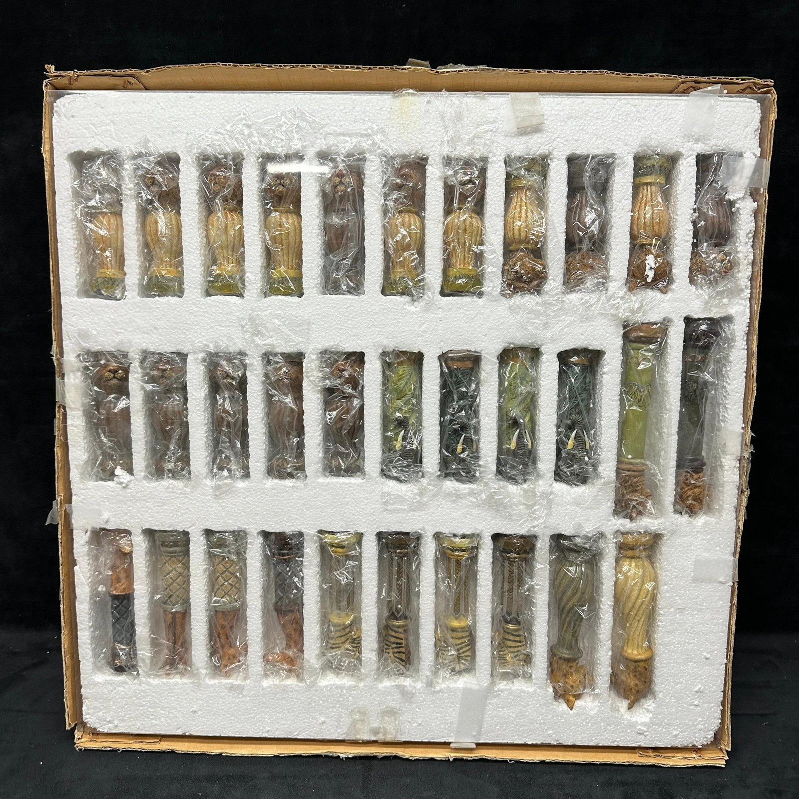 CBK Resin Jungle Wild Animal African Safari Chess Set Pieces and Chessboard: Complete set of 32 pieces housed in original fitted case. Includes original chessboard in box. Pieces show light paint wear; the outer packaging shows storage wear. Overall, a complete presentation se