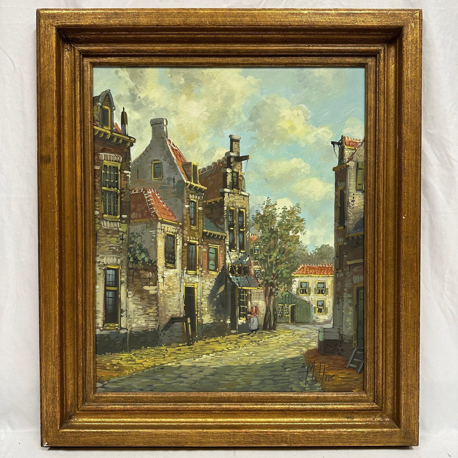 Signed Muliler European Street Scene Oil Painting Framed: Oil on canvas depicting a European street scene with brick buildings and figures. Signed lower area “Muliler” (illegible, unknown artist). Presented in a decorative gilt frame. Work appear