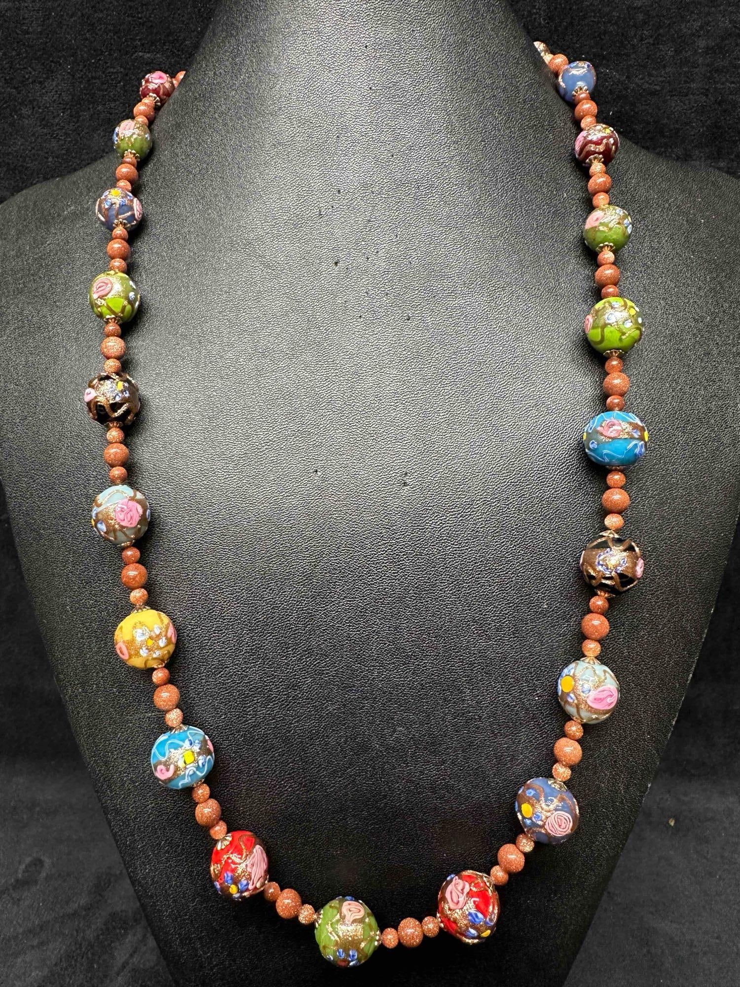 Murano Venetian Lamp Work Art Glass Multi Colored Floral Copper Design Round Bead Long Necklace F3: Murano Venetian Lamp Work Art Glass Multi Colored Floral Copper Design Round Bead Necklace F3. Necklace with multi colored glass beads with a beautiful design on each. The necklace features floral and