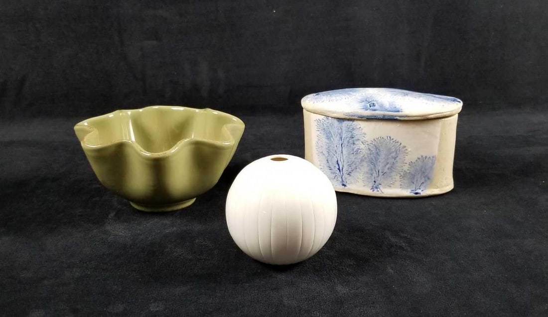 Eclectic Ceramics Lot of 3: Eclectic Ceramics lot of 3 contains: 1- Round white single stem vase. Small 1/4" yellowing at the bottom. Approx. measures 3" dia. x 3" 1-Green scalloped vase. Bottom is signed by unknown