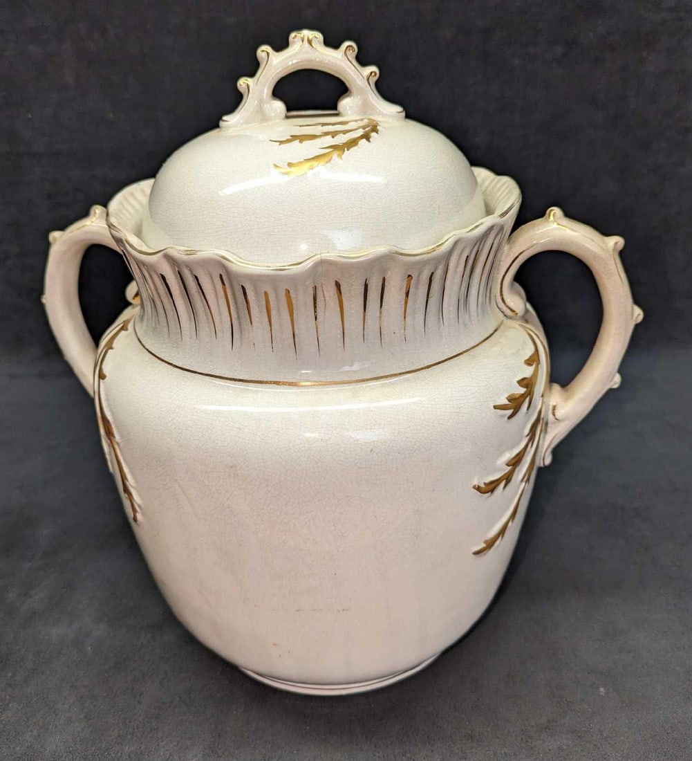 White Ironstone Porcelain Gold Accents Chamber Pot: White Ironstone Porcelain Gold Accents Chamber Pot. This is approximately 11" x 10" x 15" and it weighs 8.82 lbs. The chamber pot has some crazing, a crack, and a chip on the lid. The maker and date o