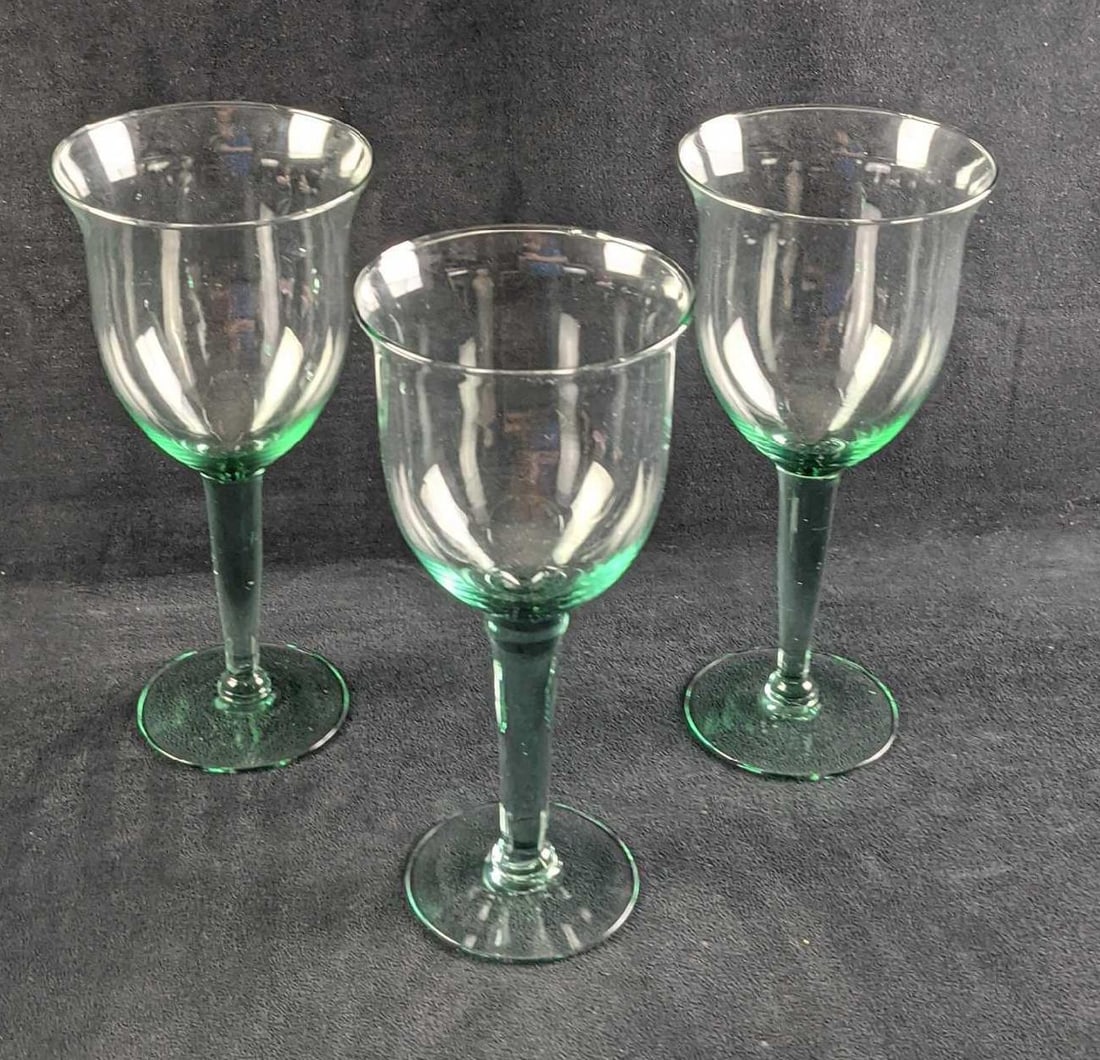 Three Large Glass Water Goblets: Three Large Glass Water Goblets. All have a hint of green/teal color in the glass, mostly in the steams. The glasses are approx 4 1/8"x 4 1/8" x 9 1/2" and they all weigh together 1.67lb. The make and