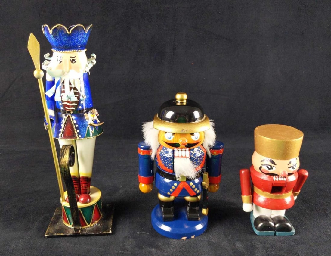 Three Battledamaged Wooden Tin Nutcrackers: These poor nutcrackers have been through so much! These are perfect for someone looking to stretch their artistic talents to fix these poor fellows! The lot includes (1) Blue, Gold And Red Wooden