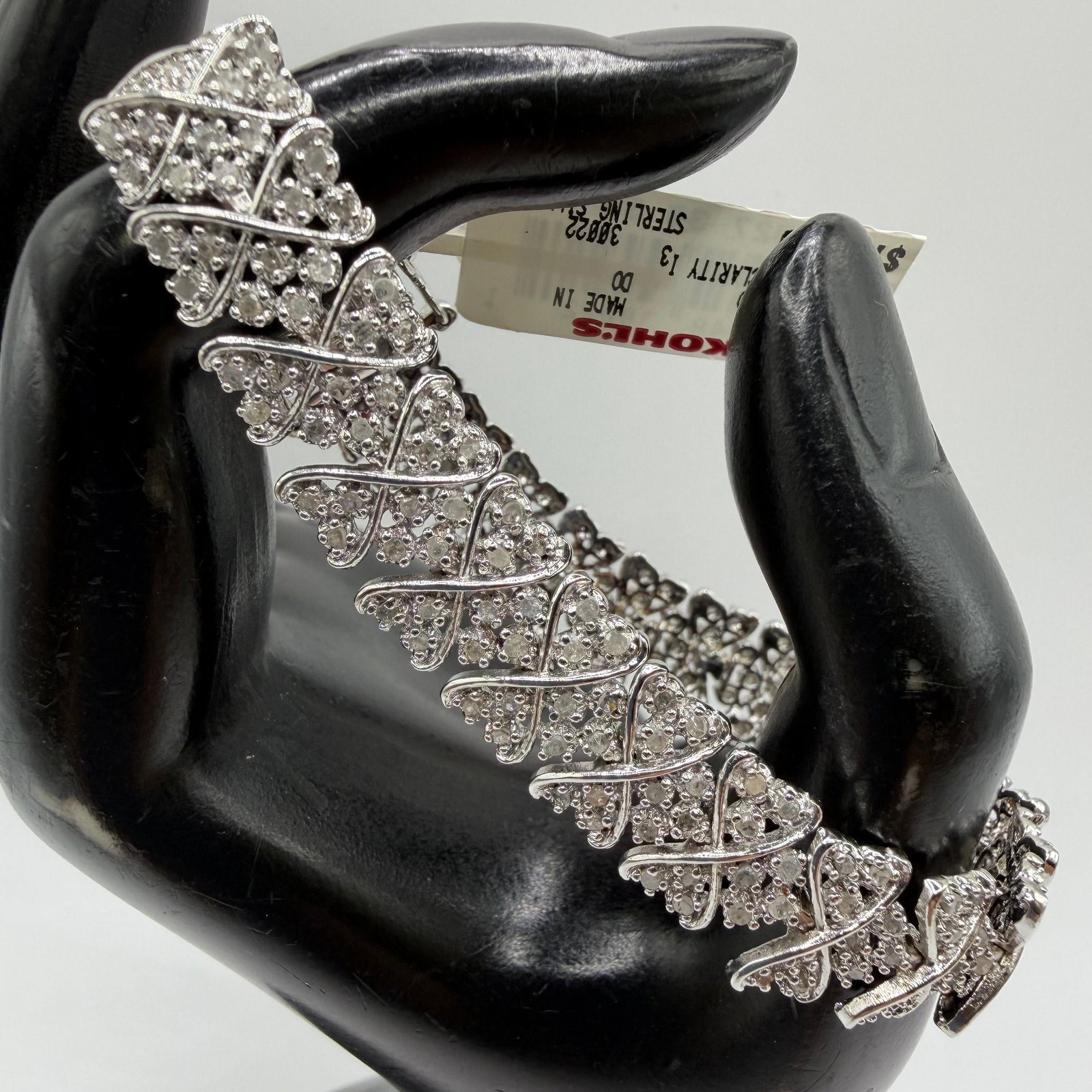 Diamond and Sterling Silver Tennis Bracelet: This item is in pre-owned, previously used/displayed condition with noticeable light wear and surface scratches. Please reference all photos for full details. This piece of jewelry has been carefully 