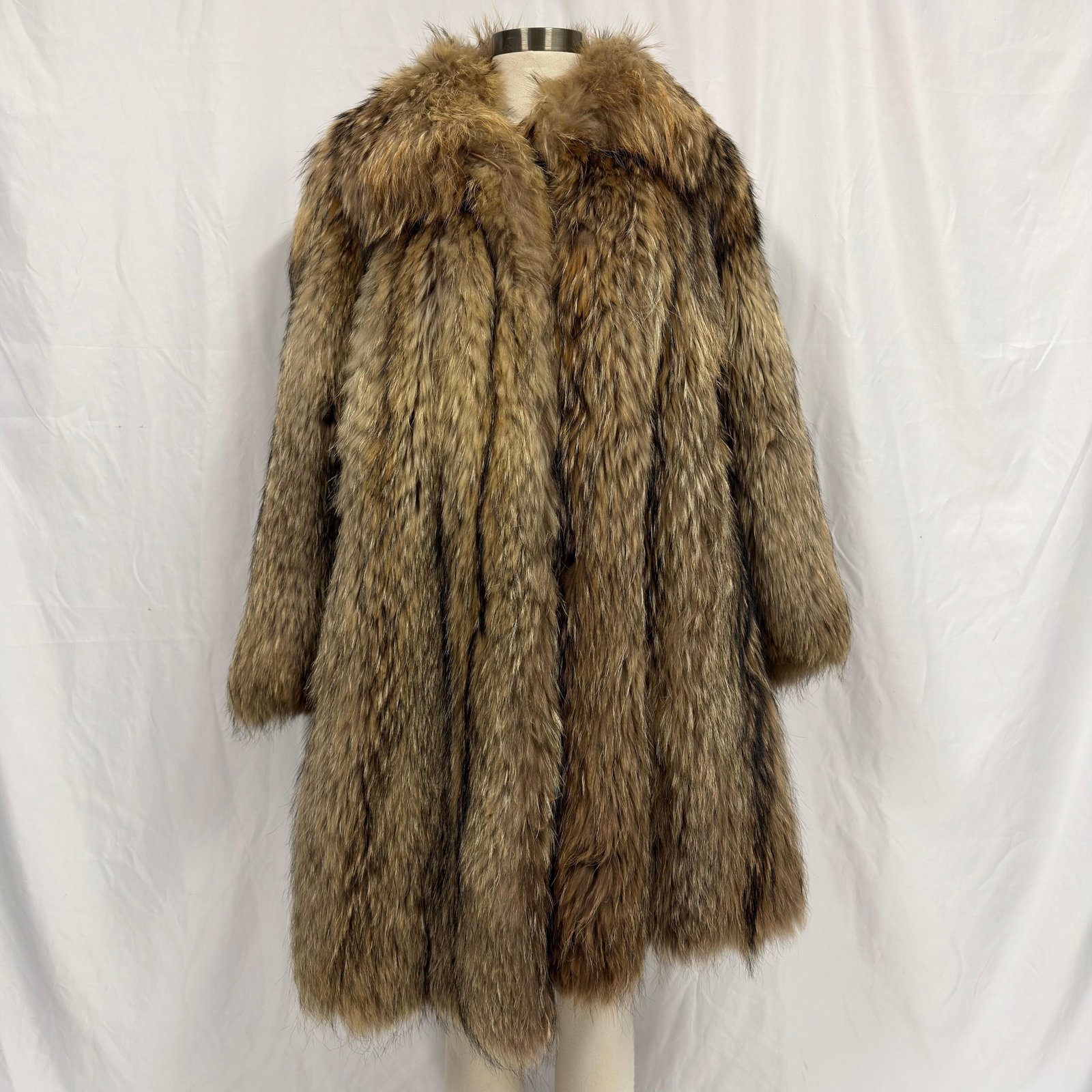 Vintage Martinello Long Full Length Fur Coat: Missing the collar button on the top area of the coat. The fur appears consistent with coyote or raccoon. The fur coat appears to be crafted from genuine fur (exact species unknown) and retains excell