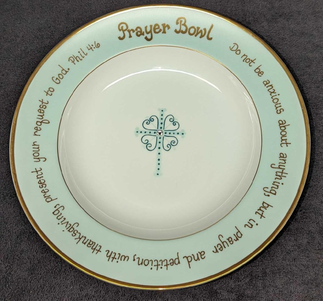 The Angie Prayer Porcelain Bowl: The Angie Prayer Porcelain Bowl. This is approximately 8 7/8" x 8 7/8" x 1 1/4" and it weighs 0.89lb. The bowl has no chips or cracks. The trimmed gold edge and hand-applied Swarovski Crystals complem