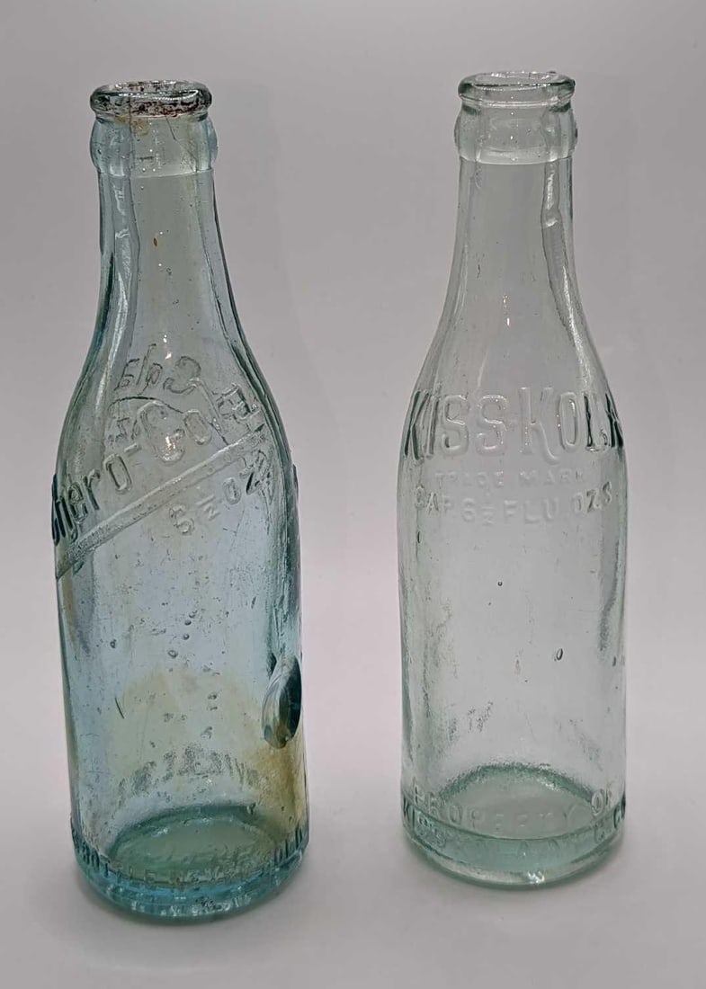 2 Vintage Kiss Kola & Chero-Cola Glass Bottles: 2 Vintage Kiss Kola & Chero-Cola Glass Bottles. This lot includes: (1) Kiss Kola 6 1/2 Oz Glass Bottle. From Highpoint, NC. This is approx 2 1/2" x 2 1/2" x 7 3/4". The bott