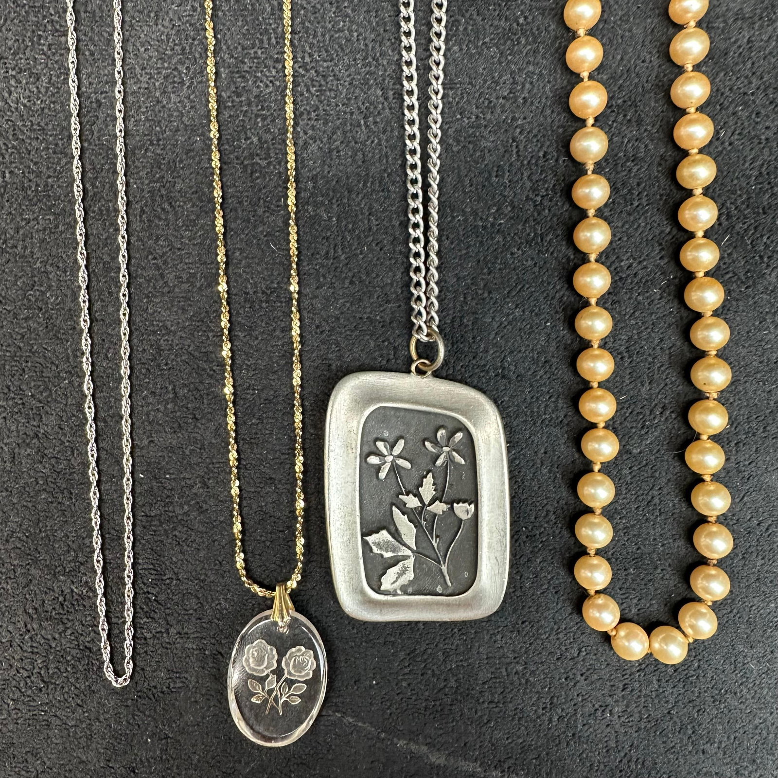 Designer Costume Jewelry Necklace Lot Napier Marvella R Tennesmed and Sterling Clasp: A lot of four assorted Designer Napier, Marvella, R. Tennesmed Sweden, and one with a sterling clasp. Designs feature a range of styles and materials, such as carved glass pendant, faux pearl bea