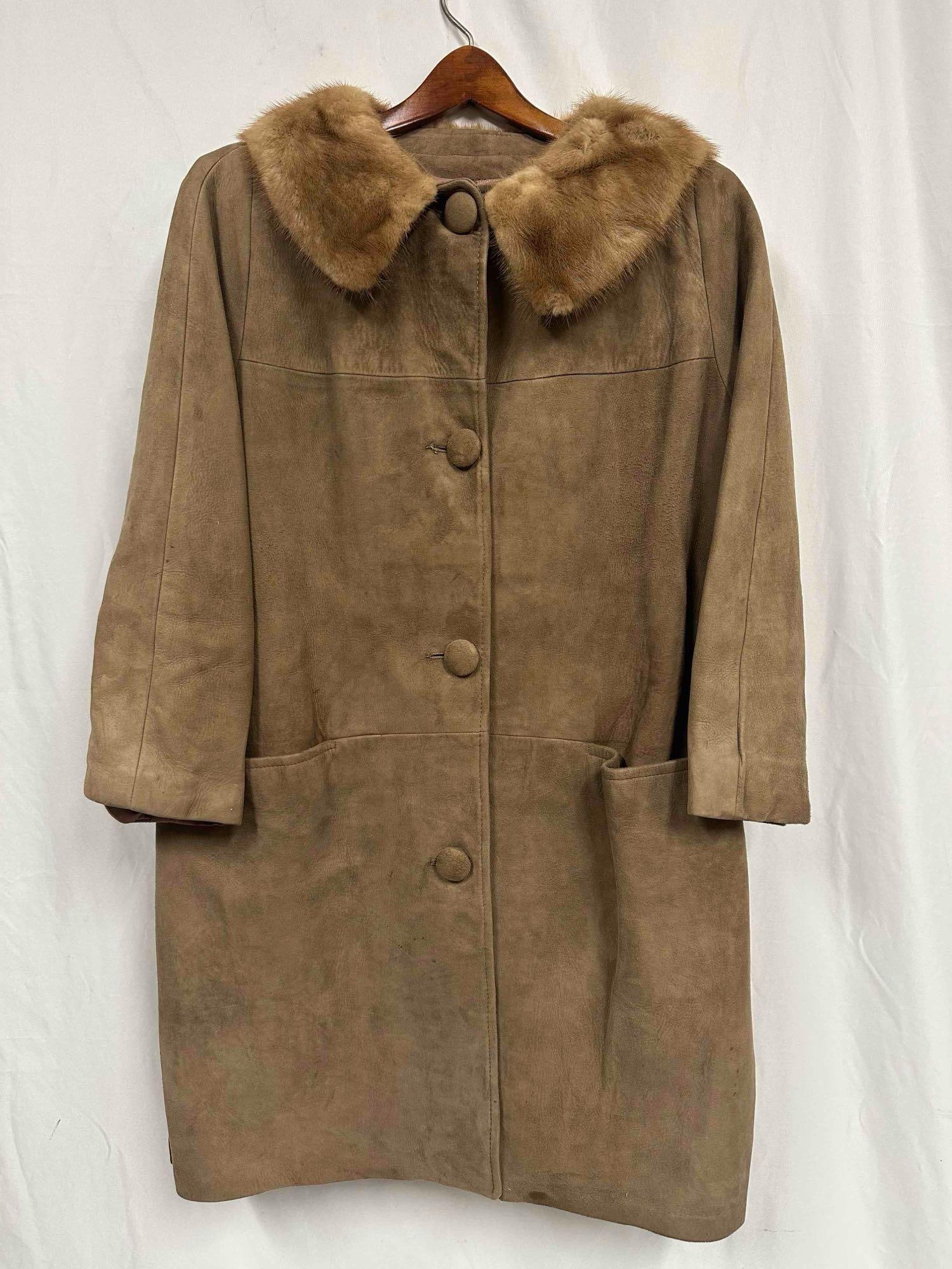 Vintage Tan Suede Mink Fur Collar Coat Button Closure: This coat features four front button closure and two front waist line pockets. The interior is a light pink orange colored silk like material. The interior of the coat shows light wear. Overall the Fu